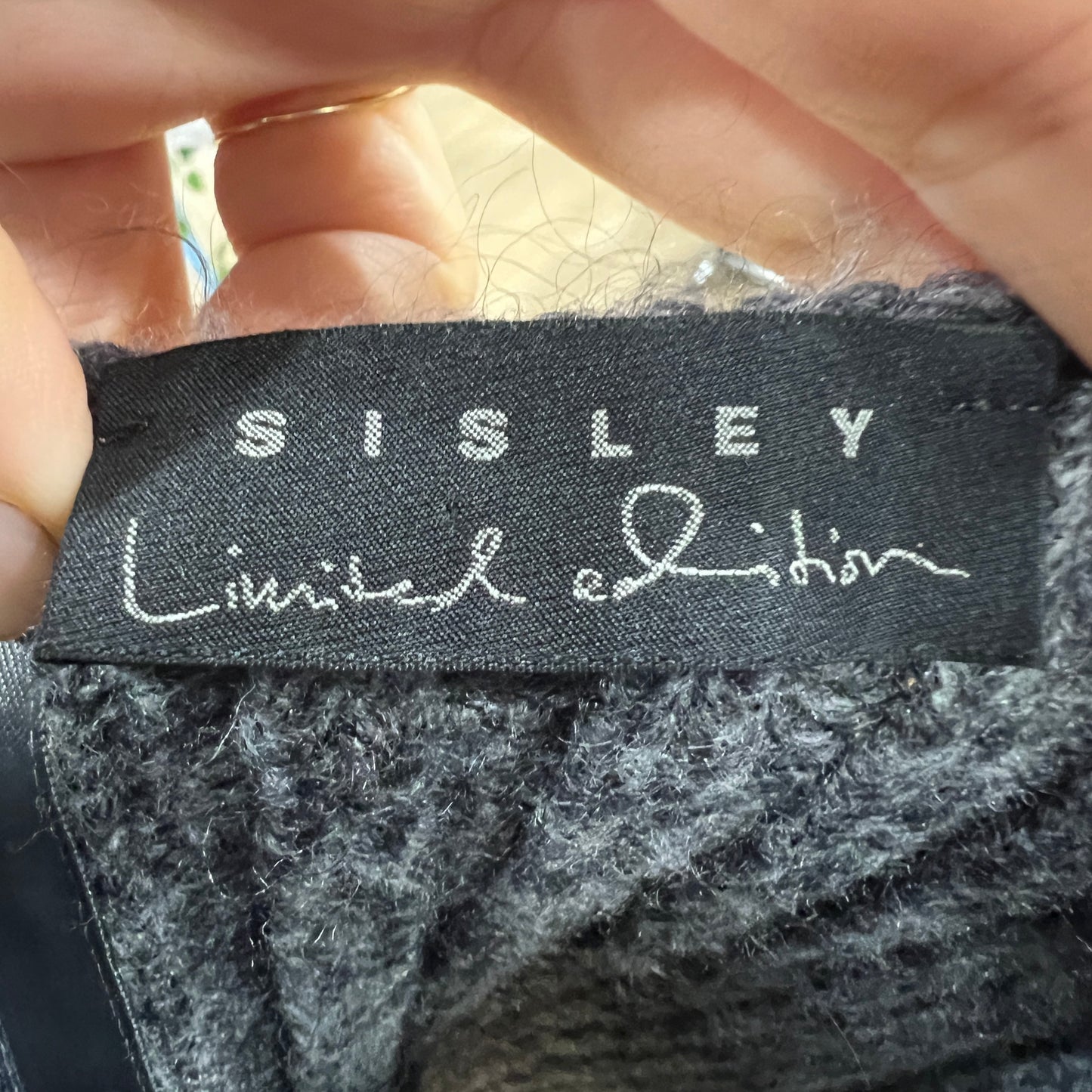 Sisley limited edition label on a textured fabric background