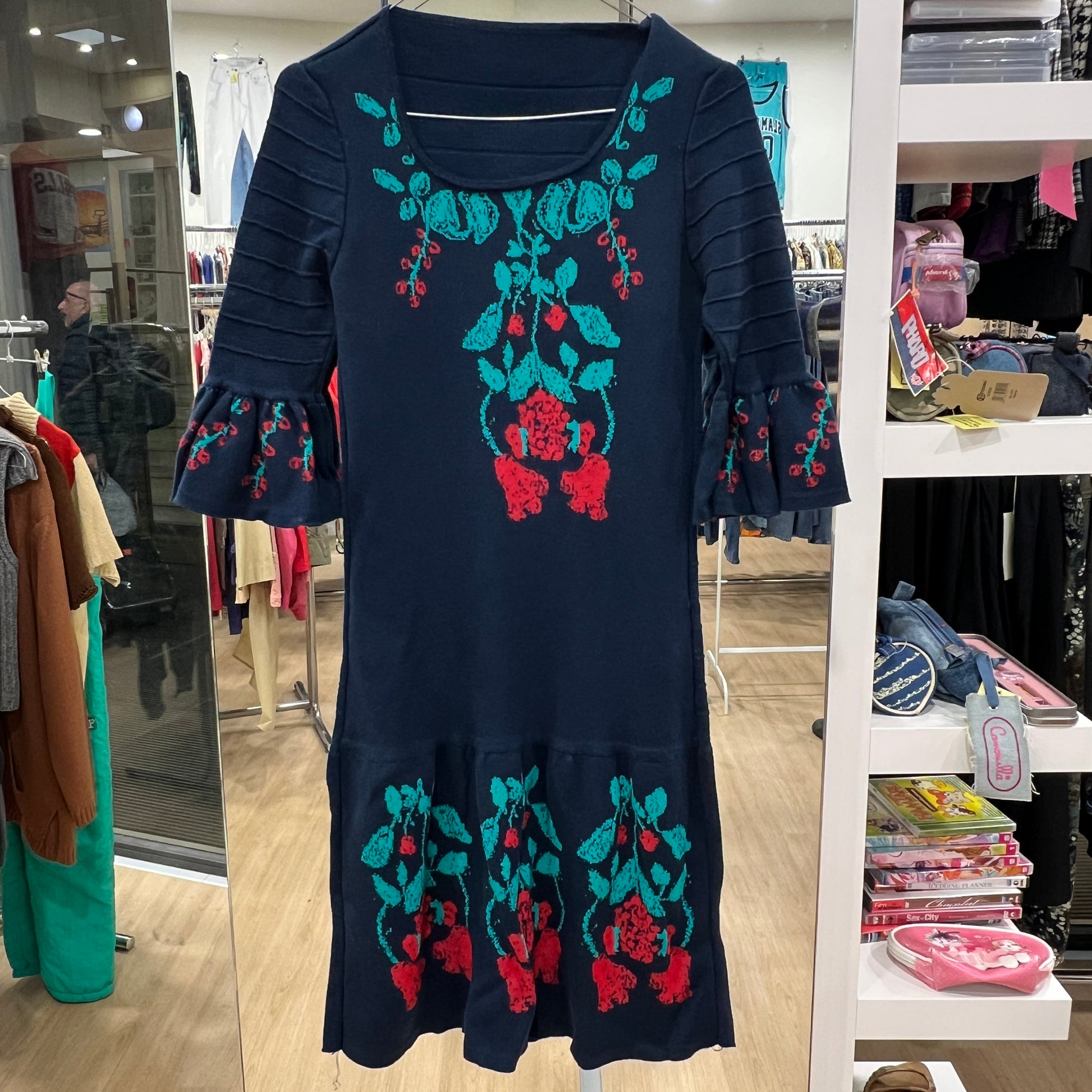 Navy blue dress with floral embroidery in a store setting