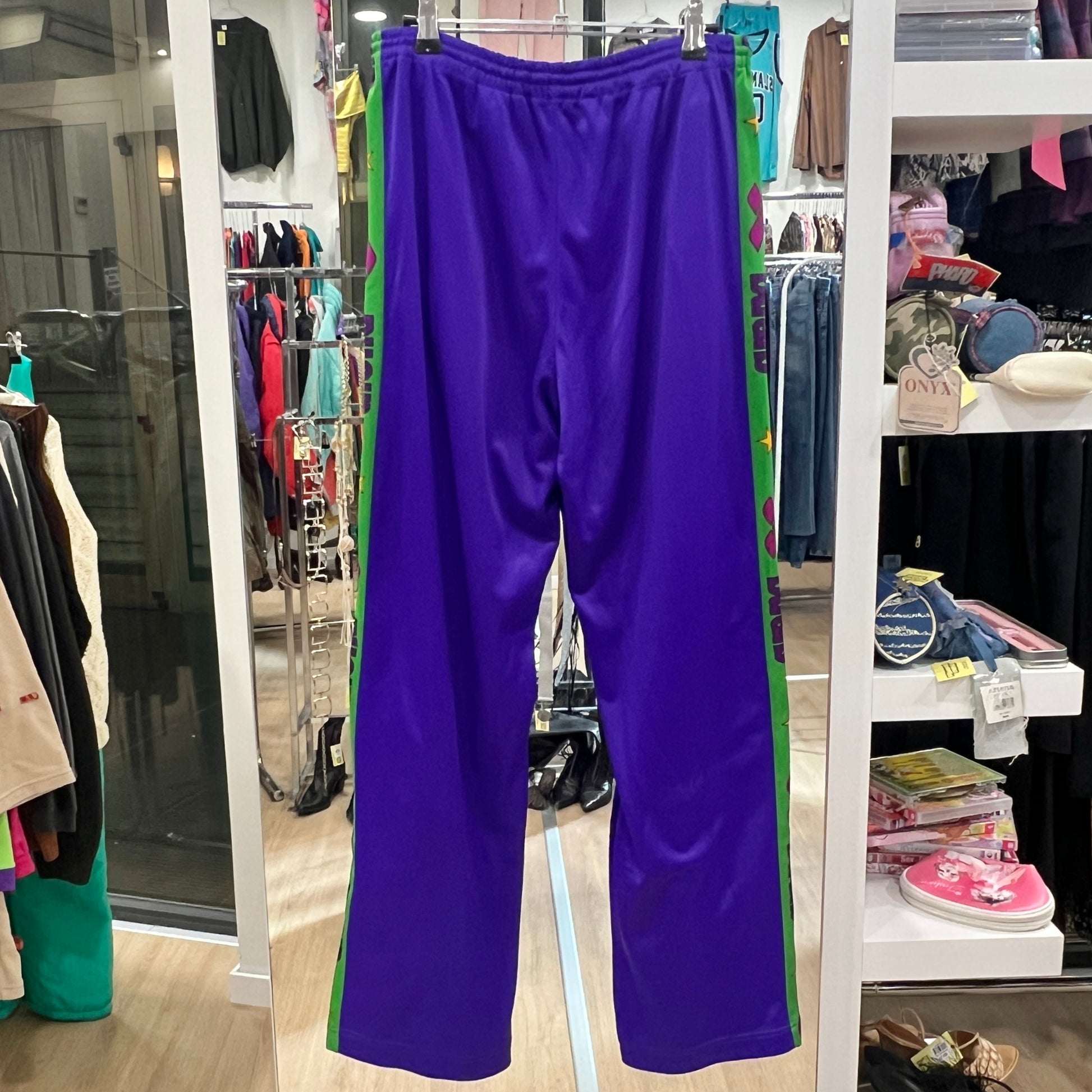 Purple pants hanging in a store with various clothing items in the background