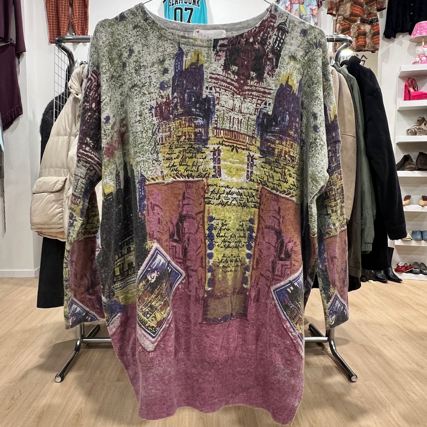 Multicolored patterned sweater on a rack in a store setting