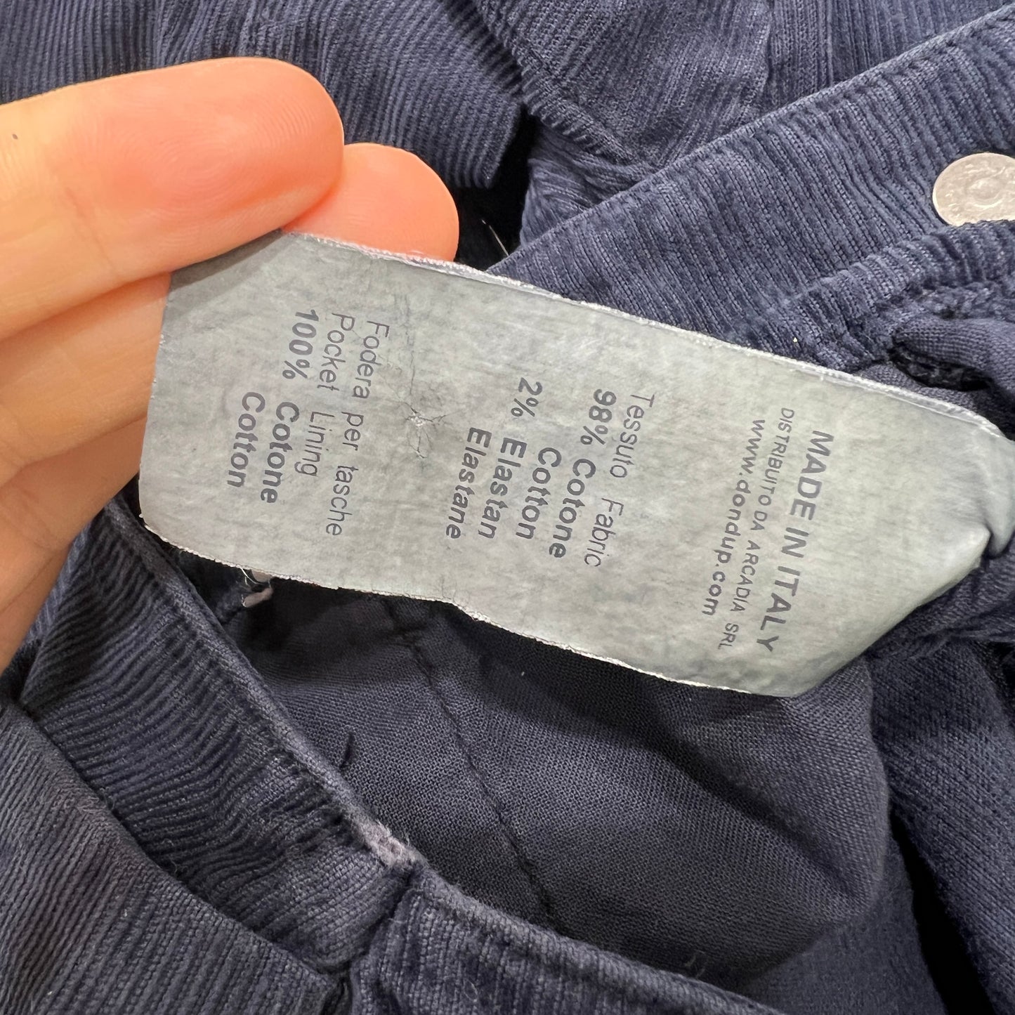 Fabric label on a piece of clothing with 'Made in Italy' text