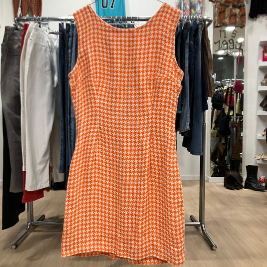 Orange patterned dress on a rack in a clothing store