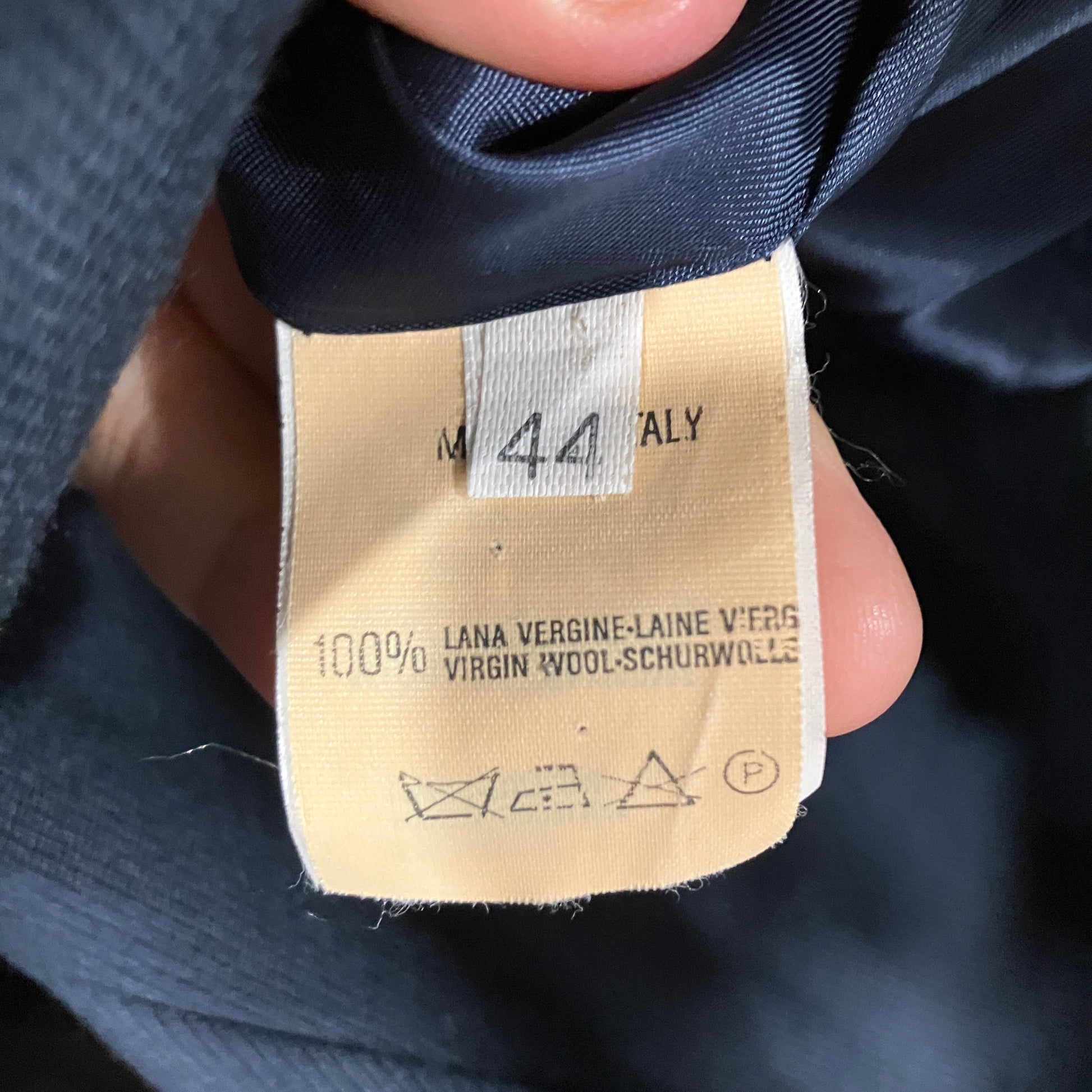 Close-up of a clothing label on a dark fabric background