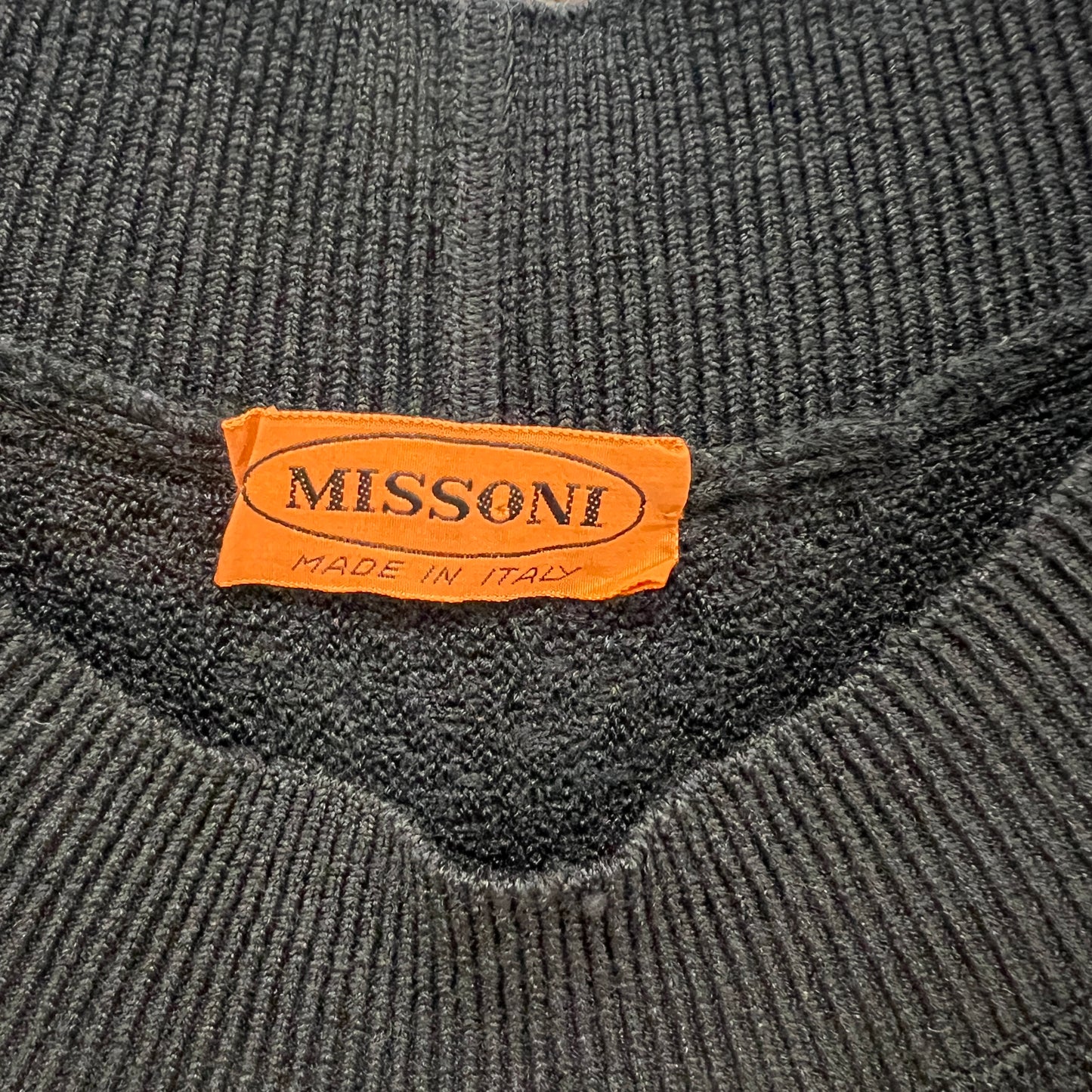 Gray knit sweater with a Missoni label on a gray background