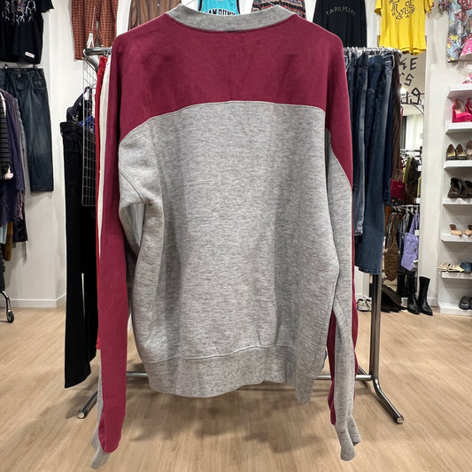 Gray and maroon sweatshirt on a rack in a clothing store