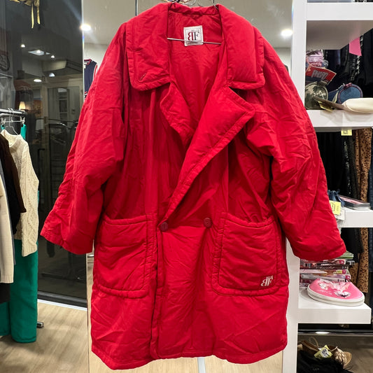 Red coat with brand logo on a rack in a store setting