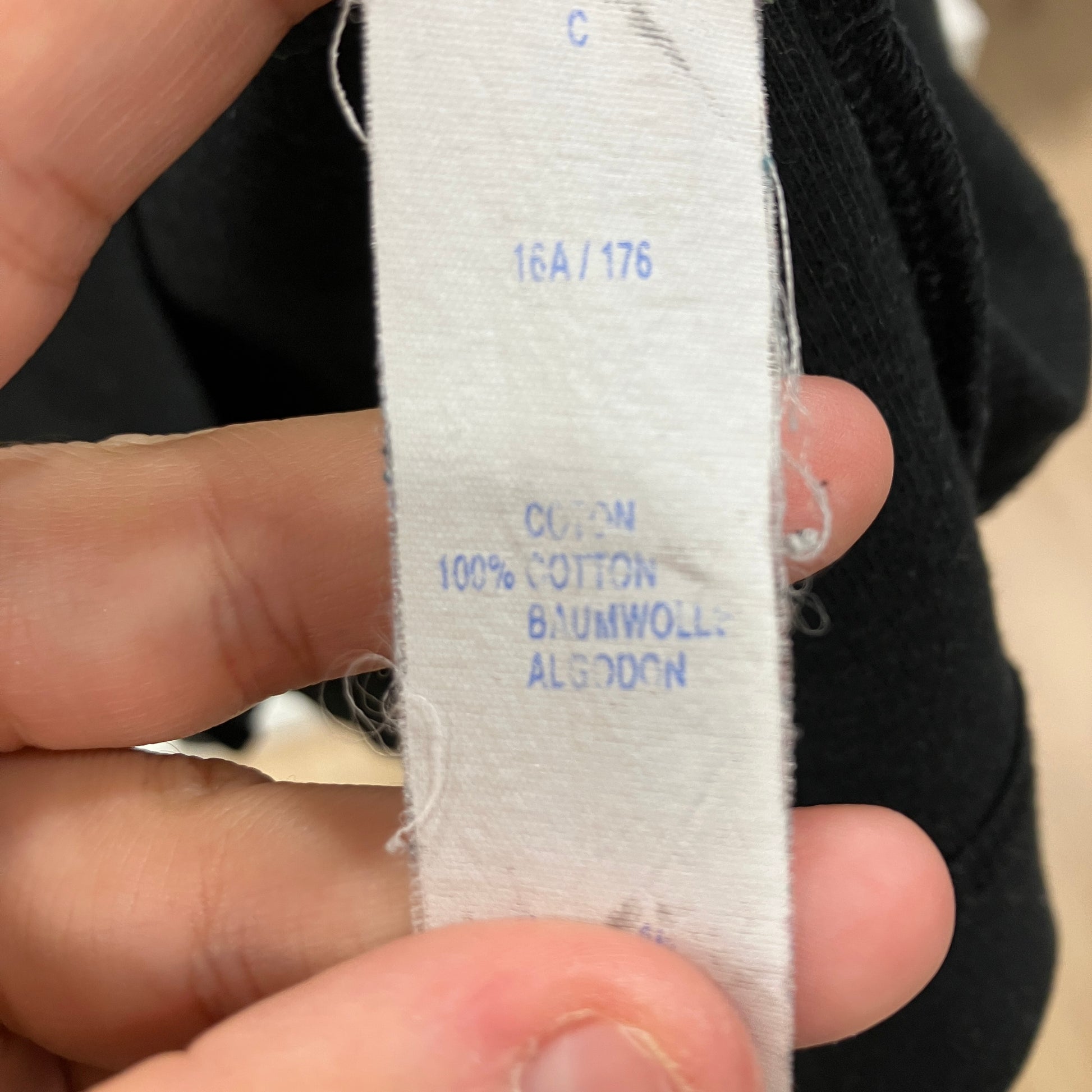 Close-up of a fabric label with text on a blurred background