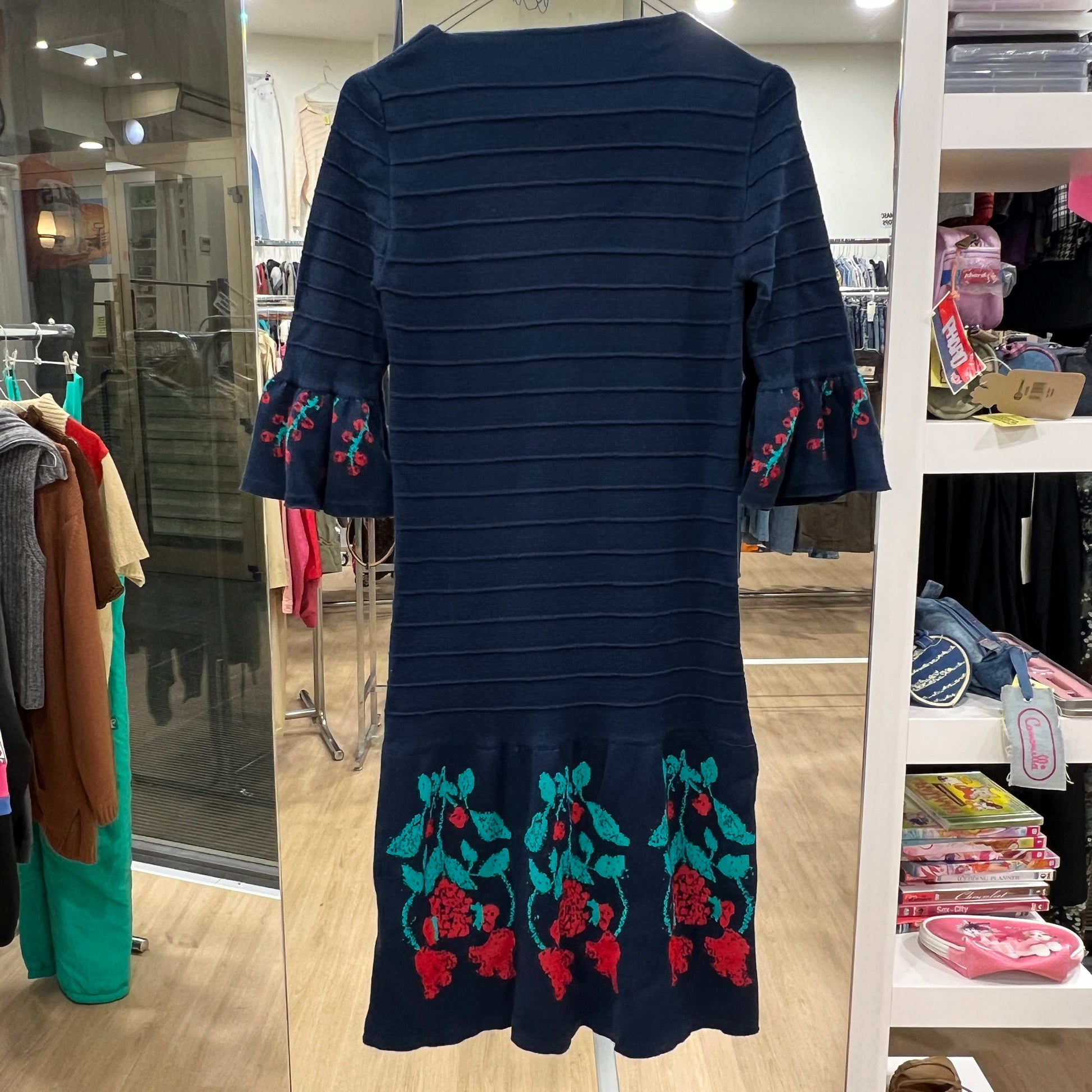 Navy blue dress with floral embroidery in a store setting