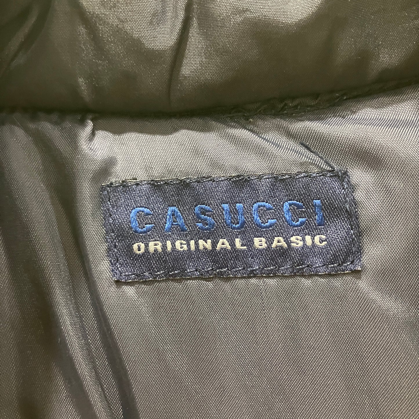 Casucci label on a gray fabric background