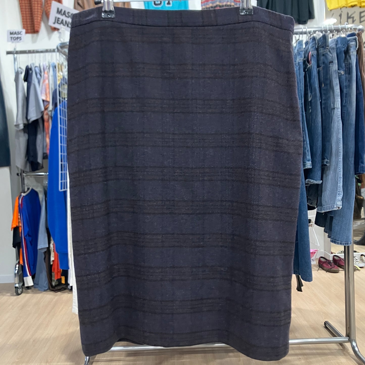 Dark skirt on a clothing rack in a store setting