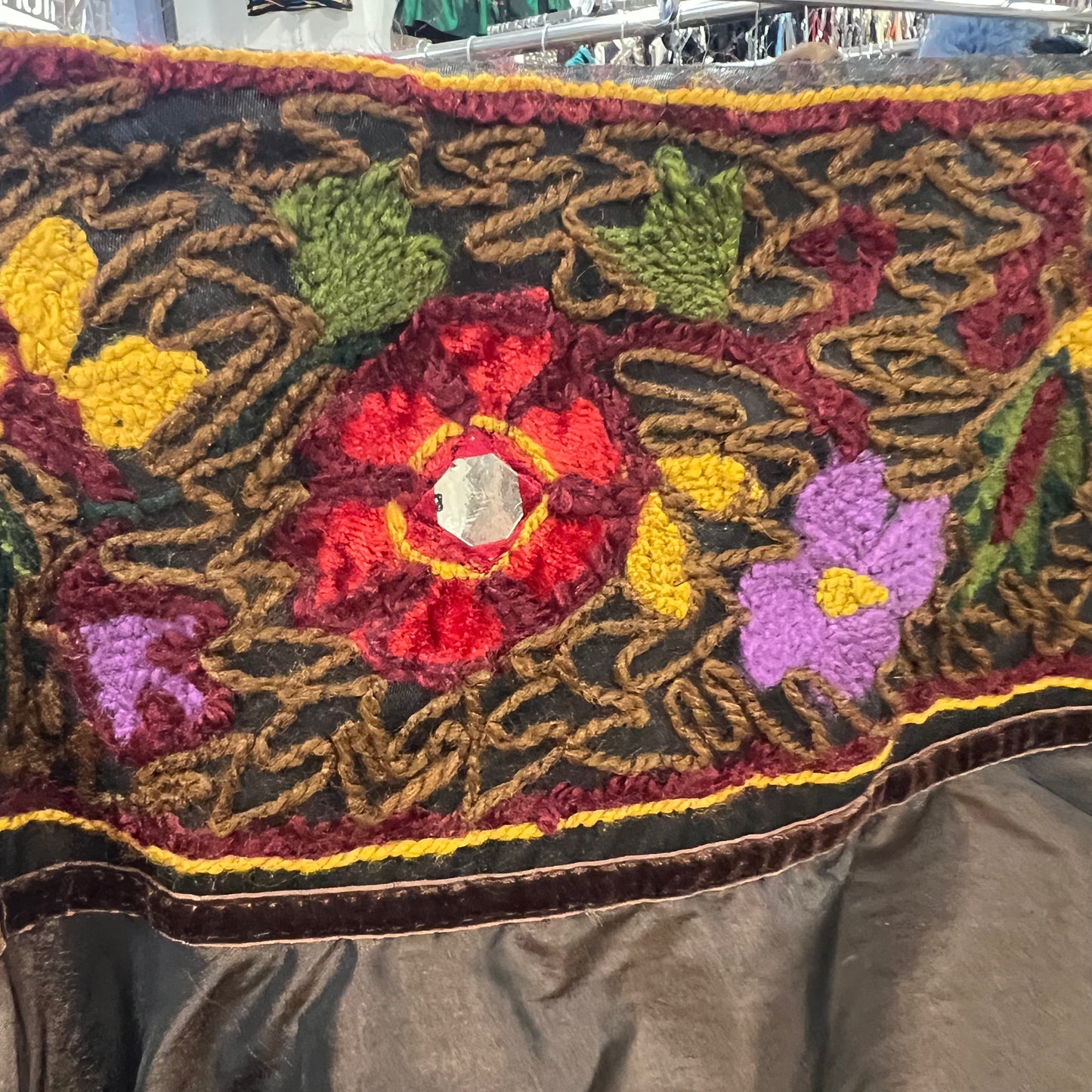 Close-up of a textured fabric with floral patterns and a dark background