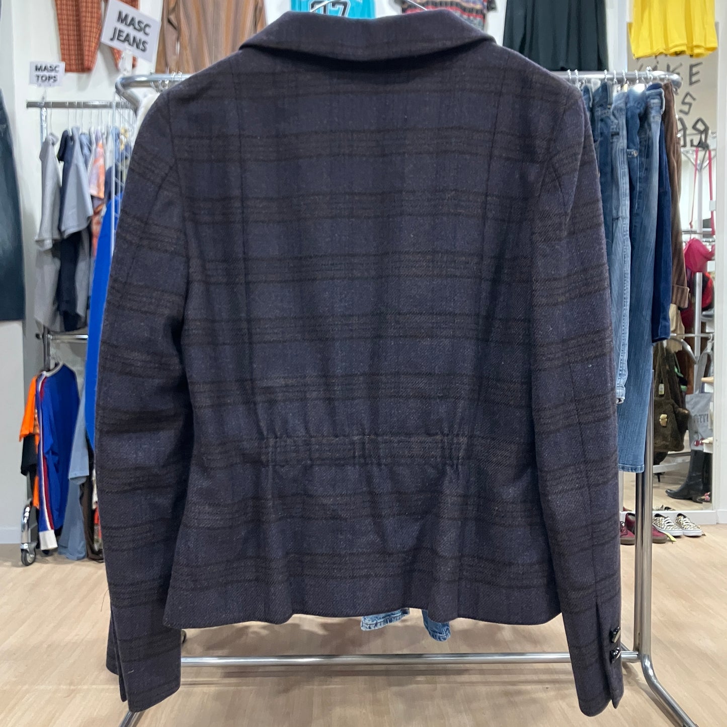 Dark plaid jacket on a rack in a clothing store