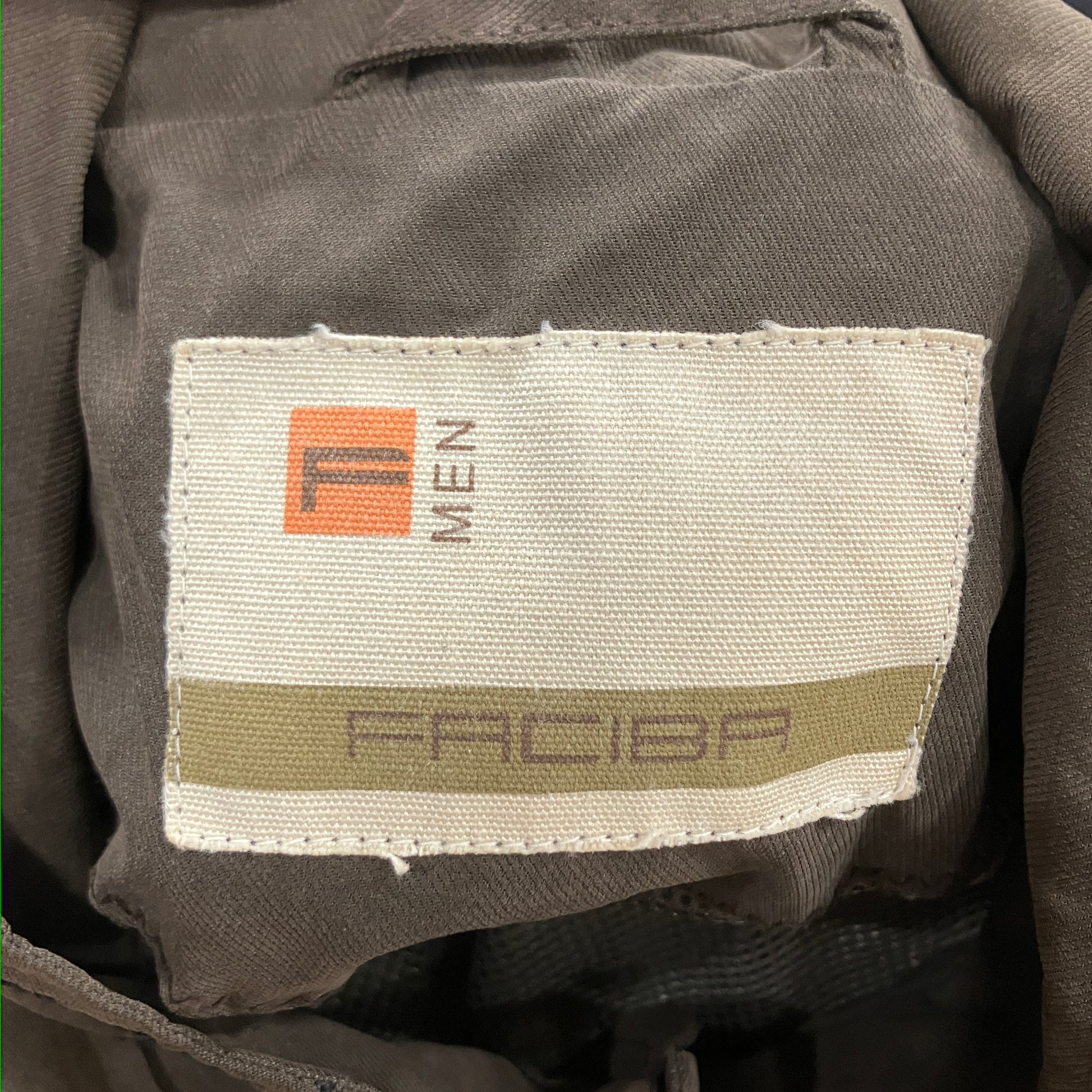 Fabric tag on a piece of clothing with visible branding and text