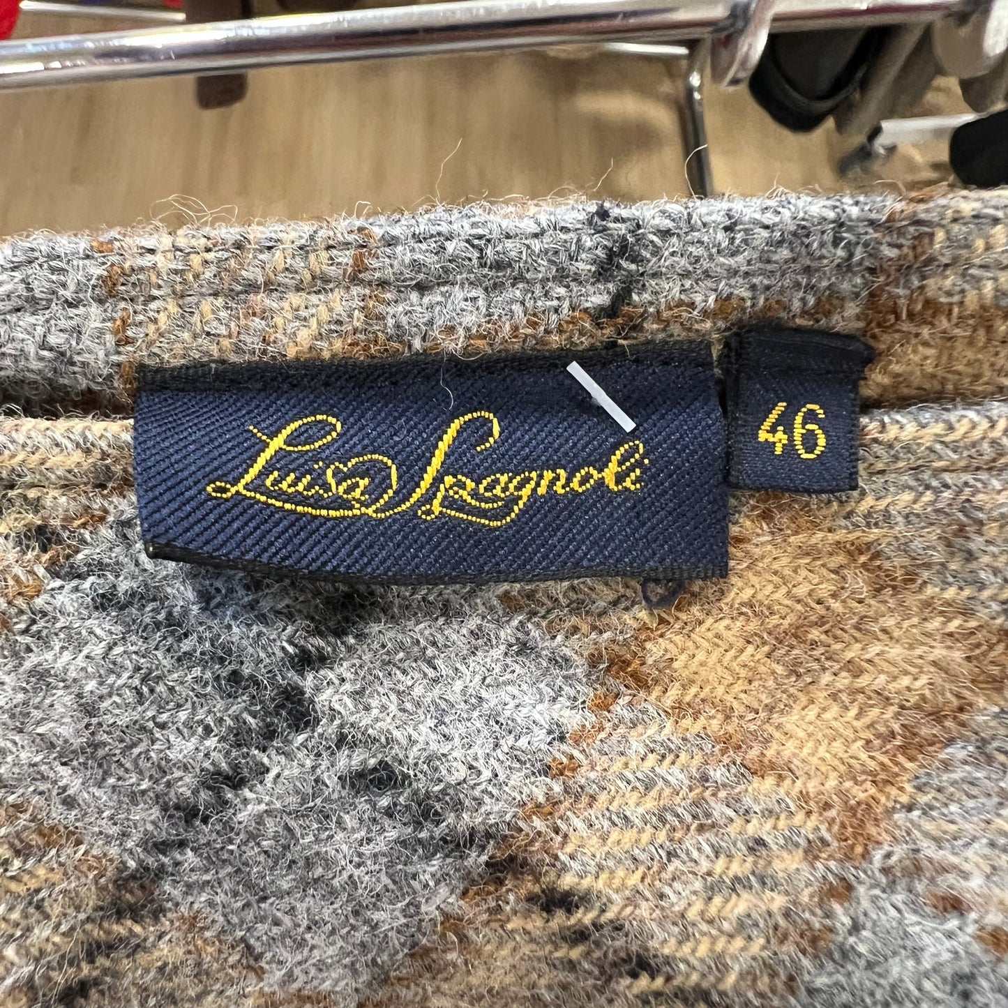 Textile with a brand label and size tag on a textured fabric background