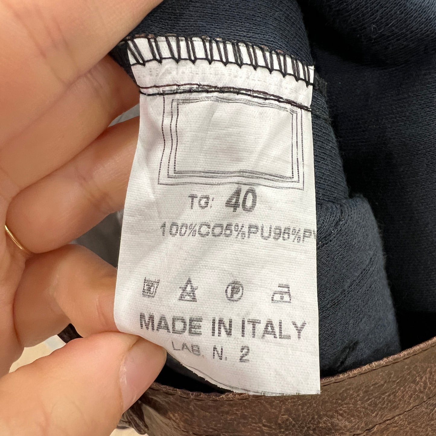 Close-up of a clothing label on a product with 'Made in Italy' text