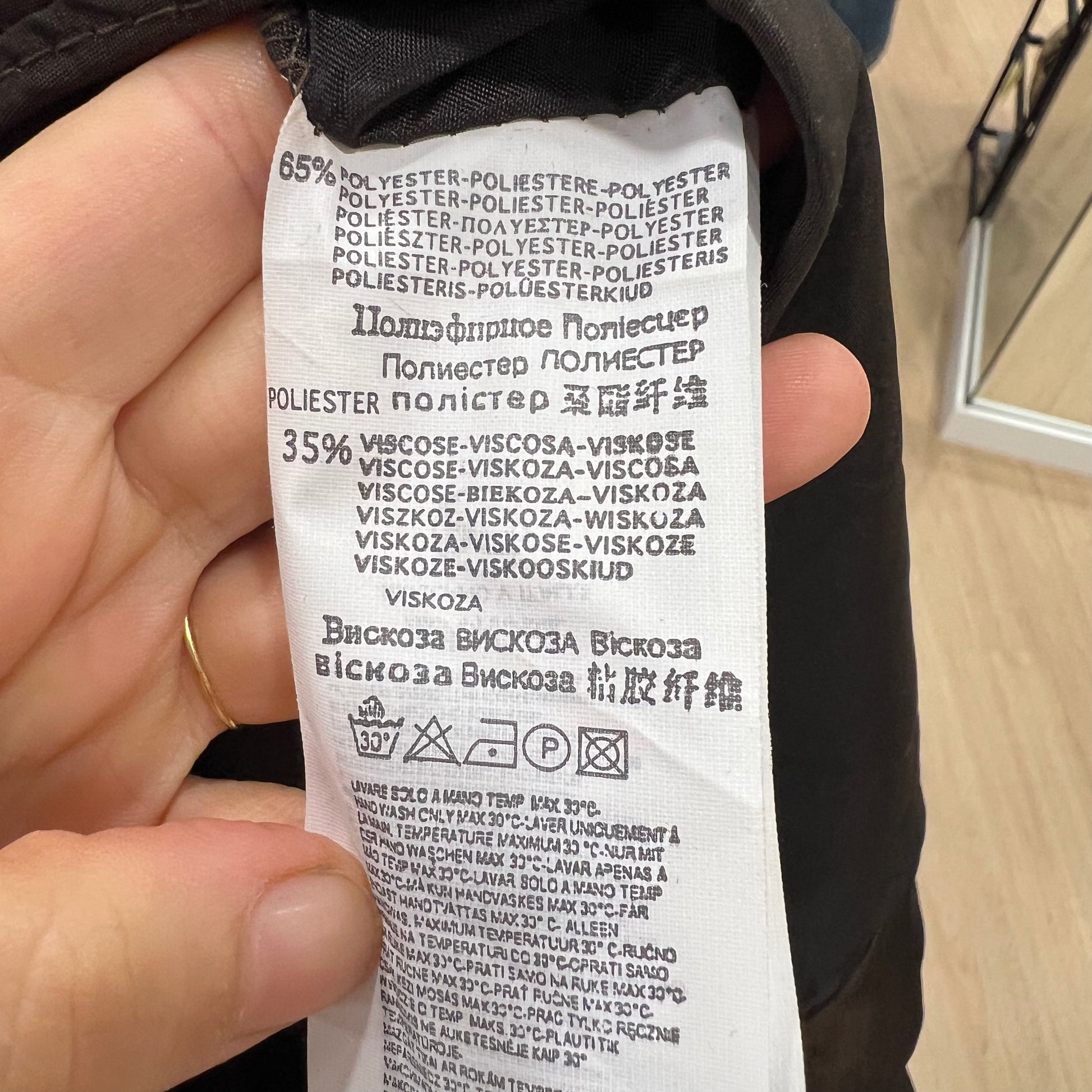 Close-up of a fabric label with text on a blurred background