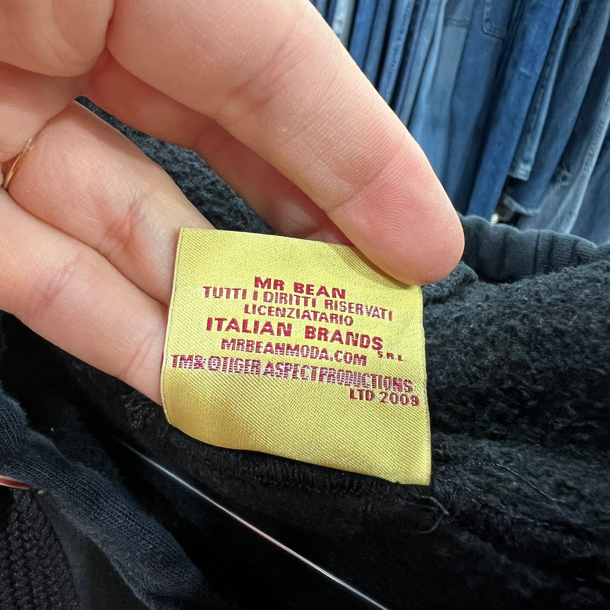 Yellow label on a dark fabric background with red text