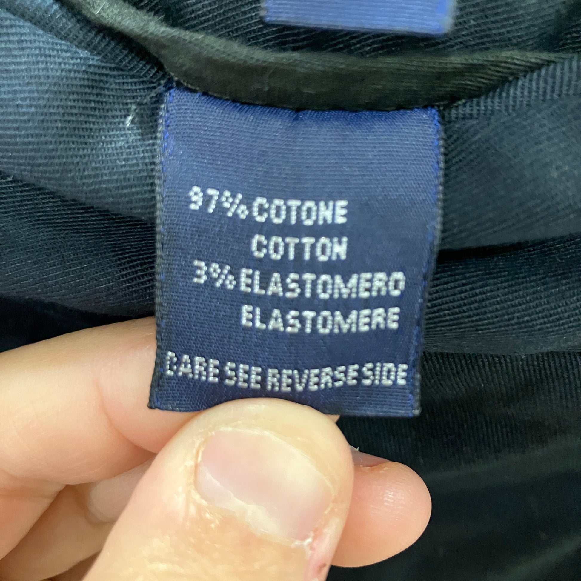 Clothing label with text on a dark fabric background