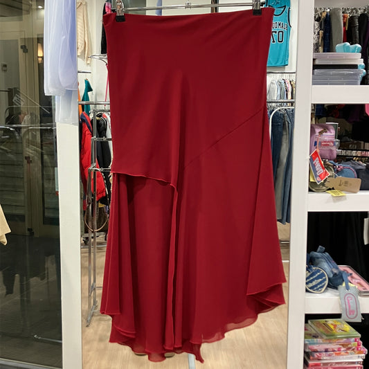 Red skirt hanging on a rack in a store setting