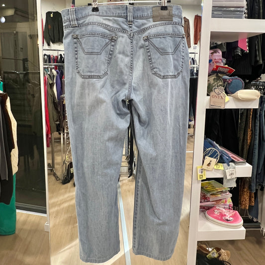 Light blue jeans hanging on a rack in a store setting