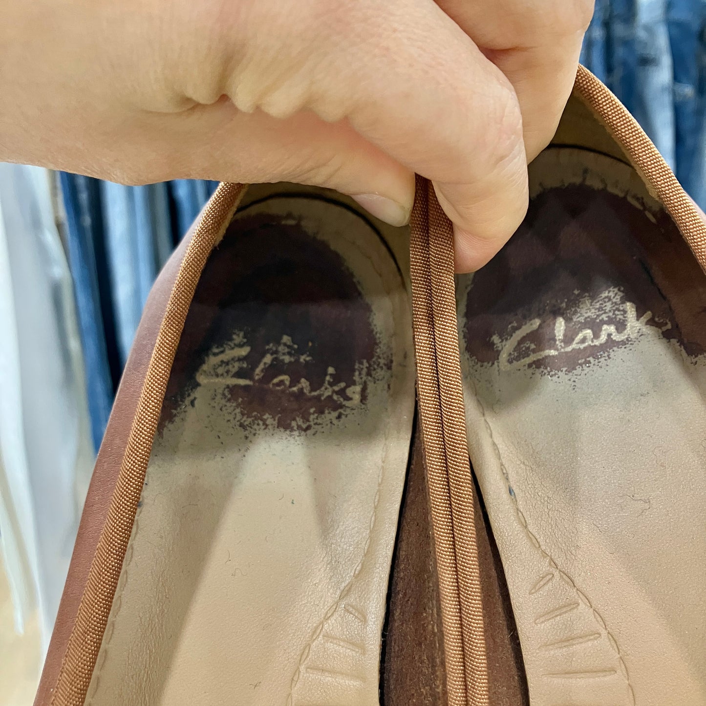 Close-up of a brown shoe with 'Clarks' branding on the sole