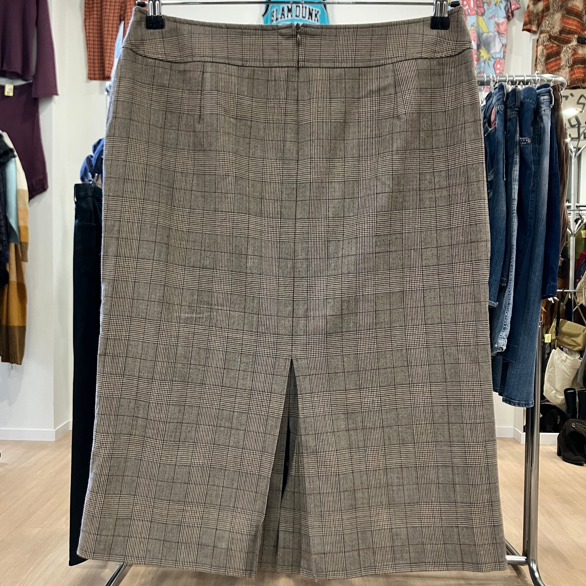 Plaid skirt hanging on a rack in a store setting