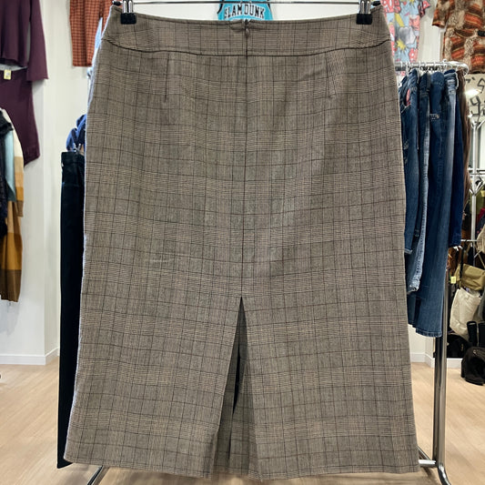 Plaid skirt hanging on a rack in a store setting