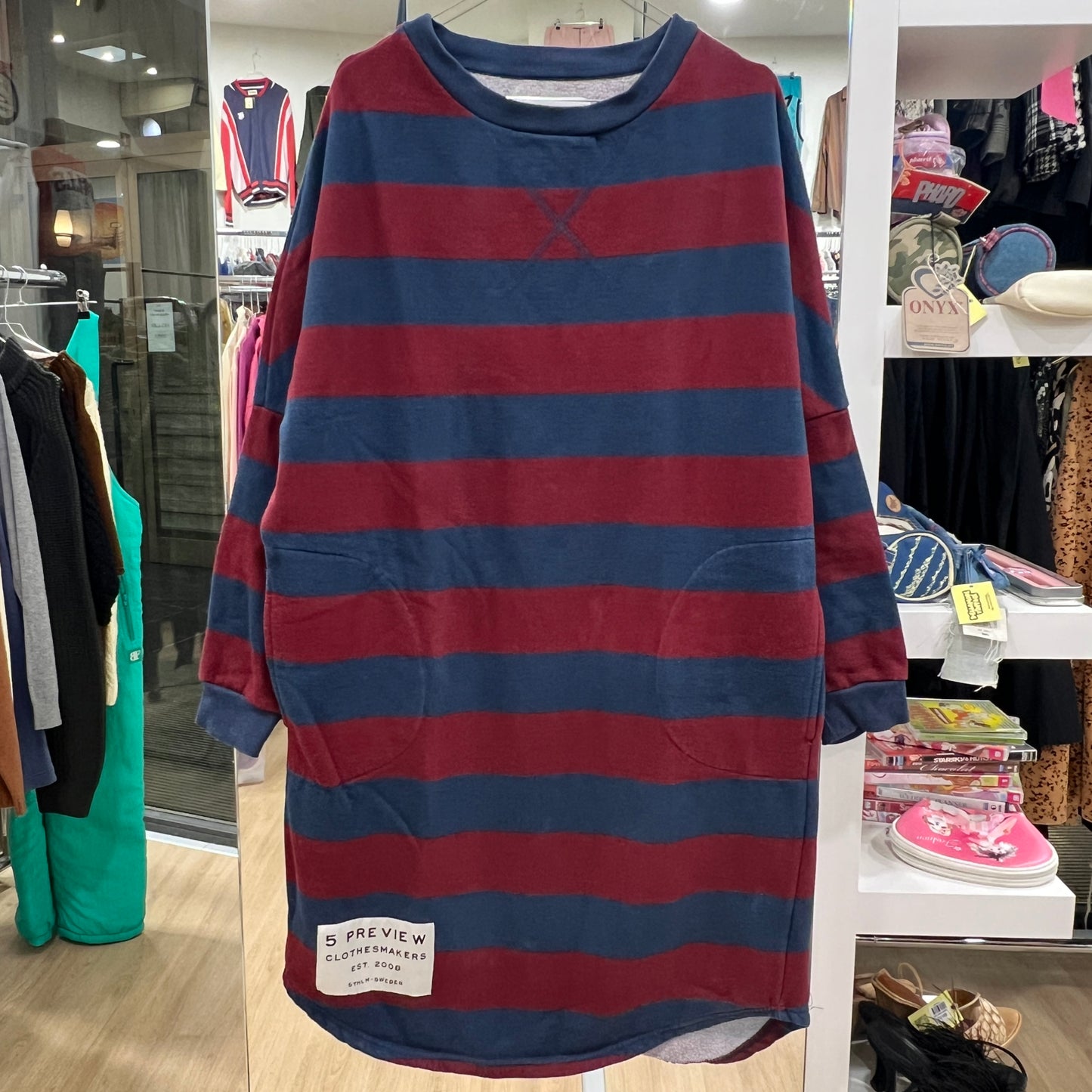 Red and blue striped dress on a rack in a store setting