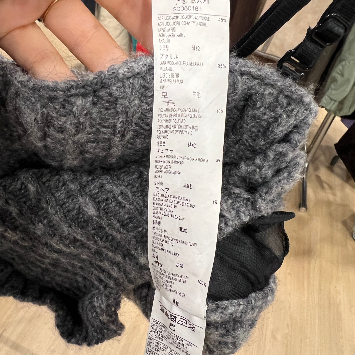 Gray knitted sweater with a long receipt overlay