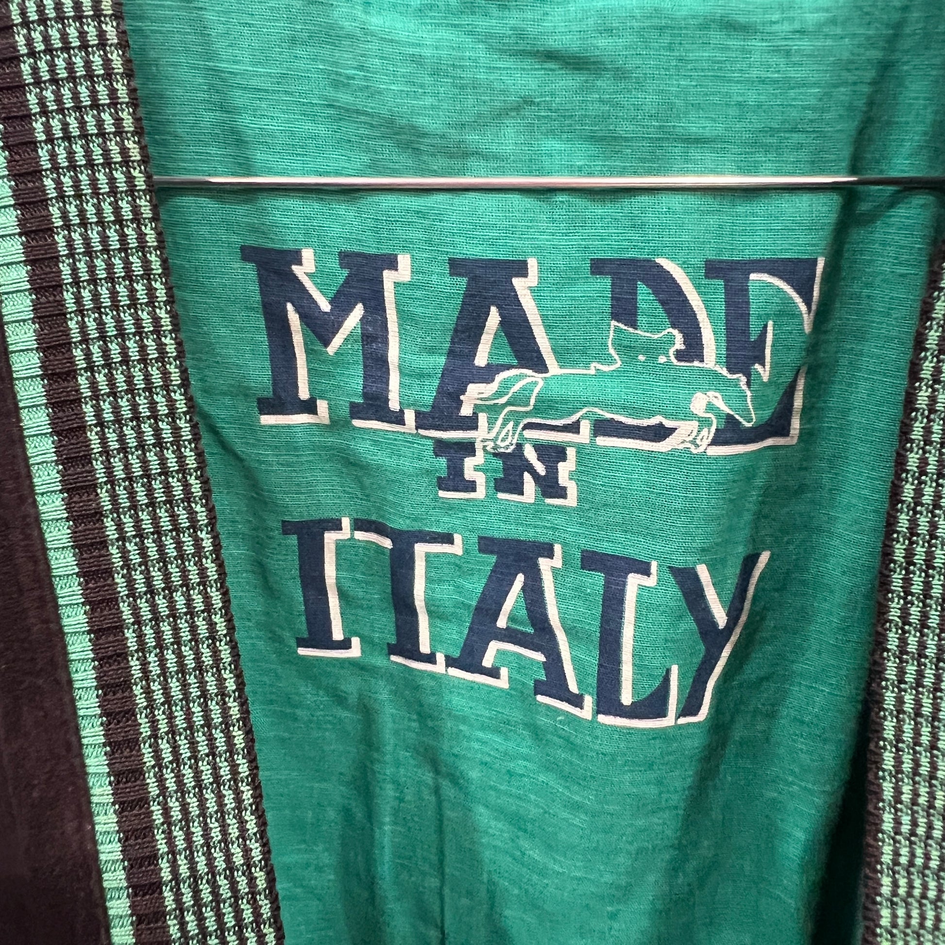 Green fabric with 'MADE IN ITALY' text and map design