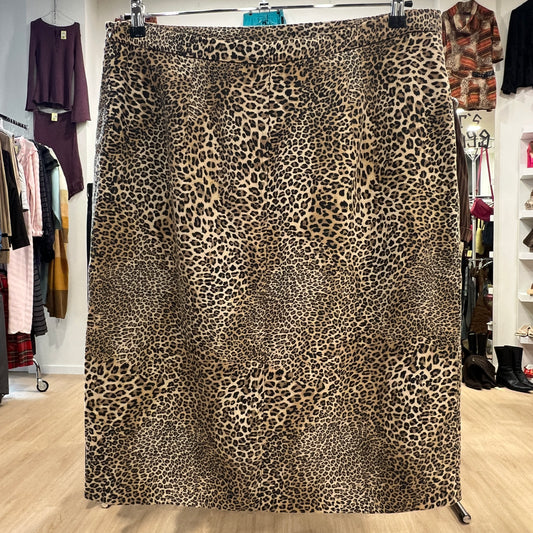 Leopard print skirt hanging in a store with clothing racks in the background
