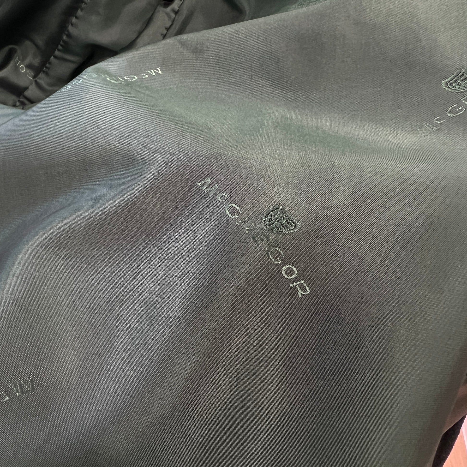 Close-up of a textured fabric surface with 'Nicce & Nyc' branding