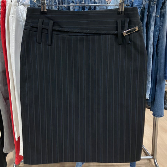Black pinstripe skirt on a rack with other clothing items