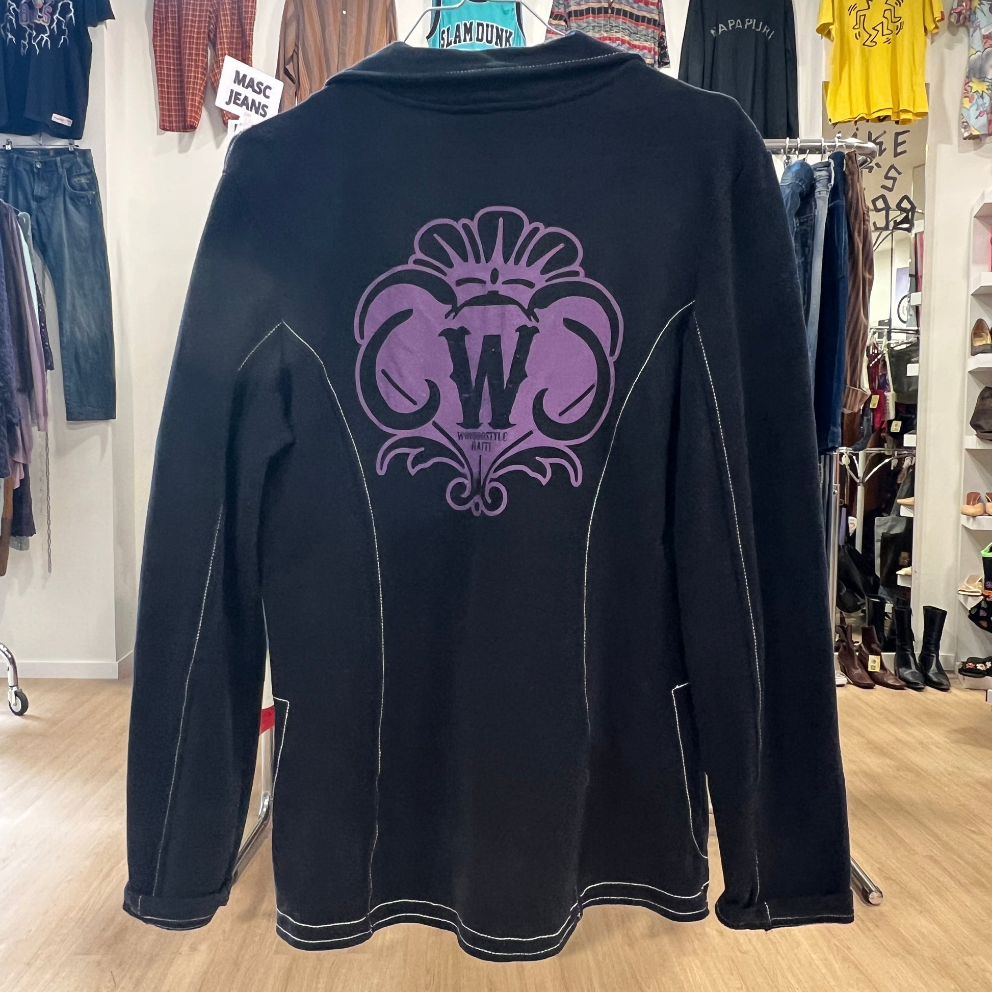 Black sweatshirt with a purple logo in a clothing store