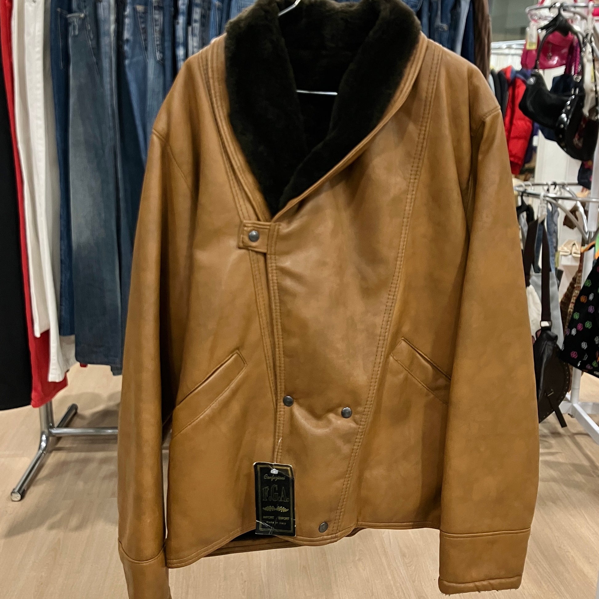 Brown leather jacket with black fur collar on a rack in a store
