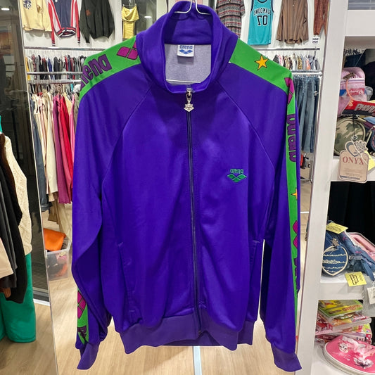 Purple jacket with green accents hanging in a store