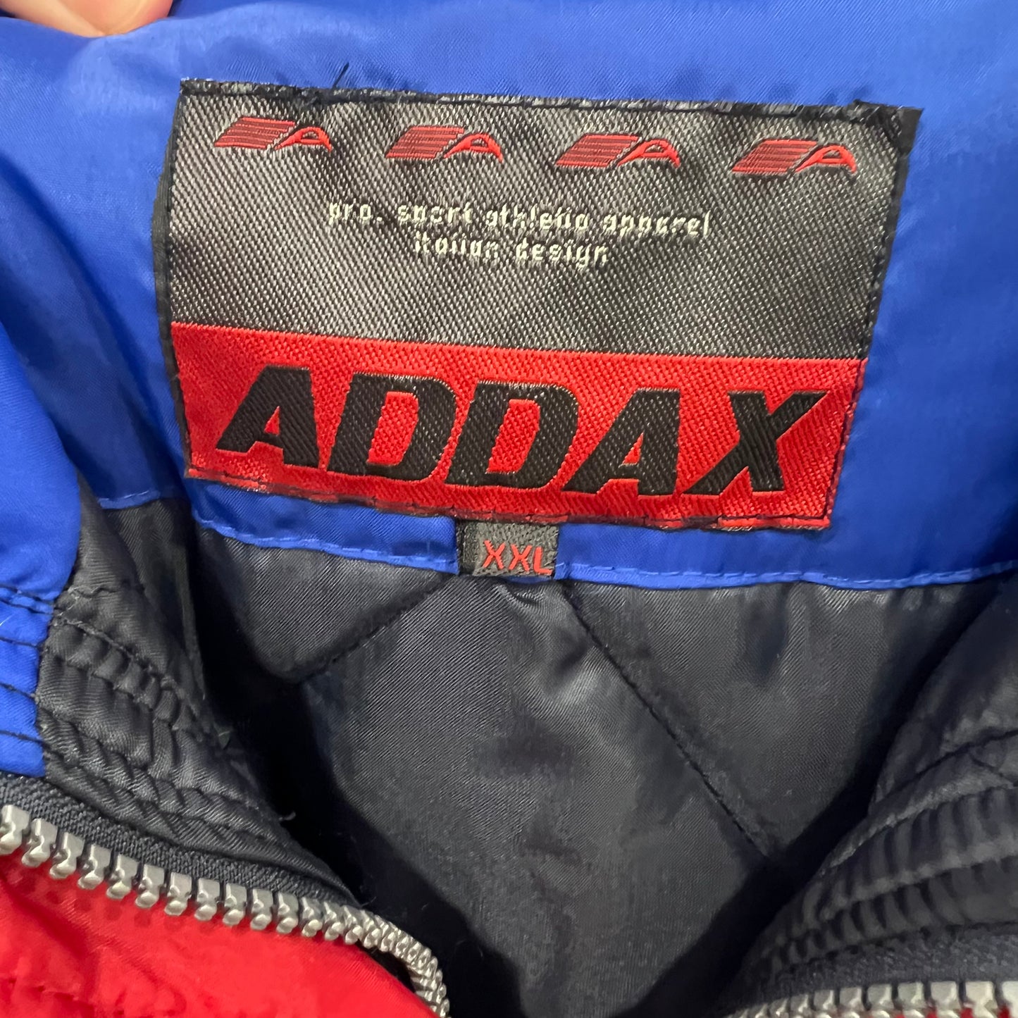 ADDAX label on a jacket with blue, red, and black colors