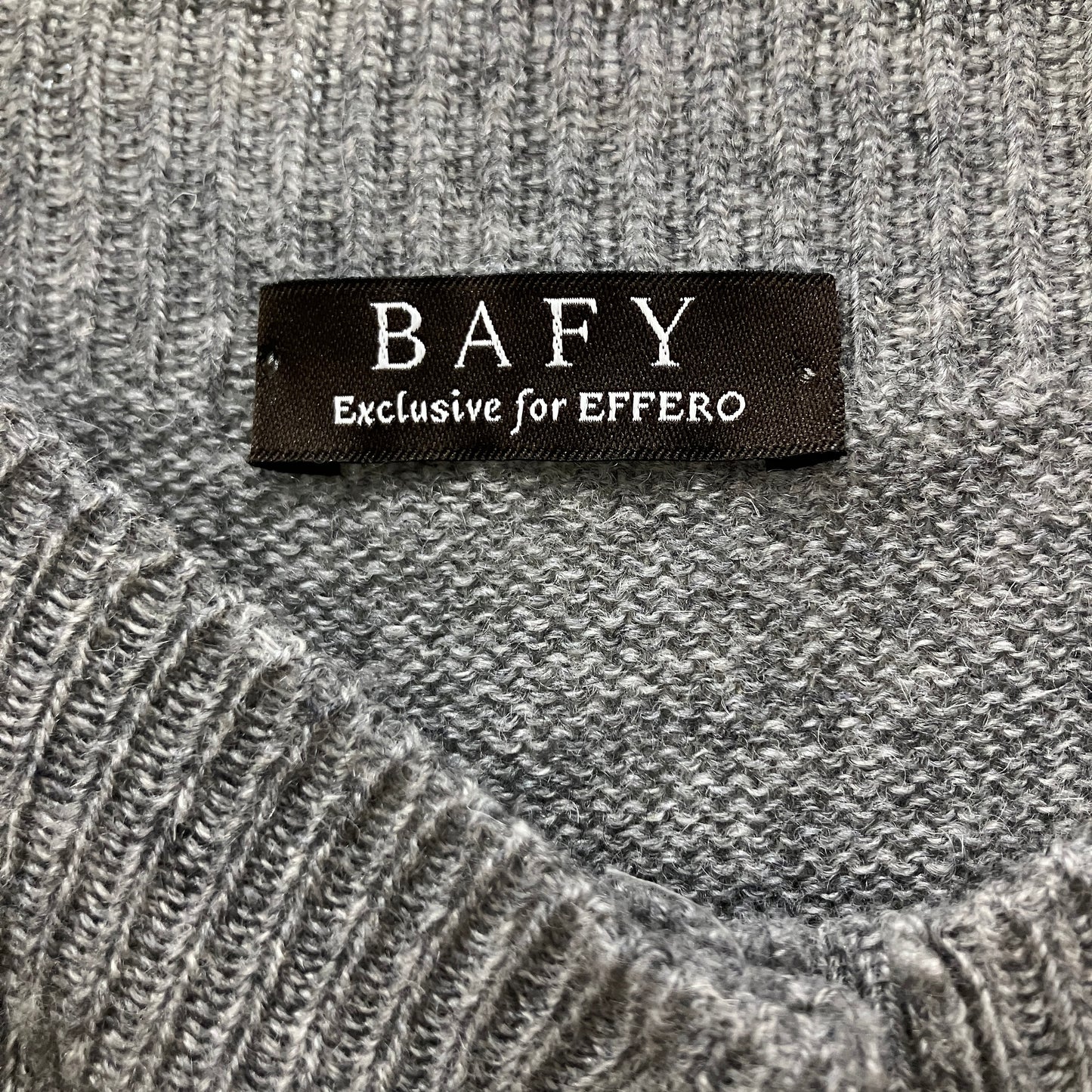 Text label 'BAFY Exclusive for EFFERO' on a textured gray fabric background