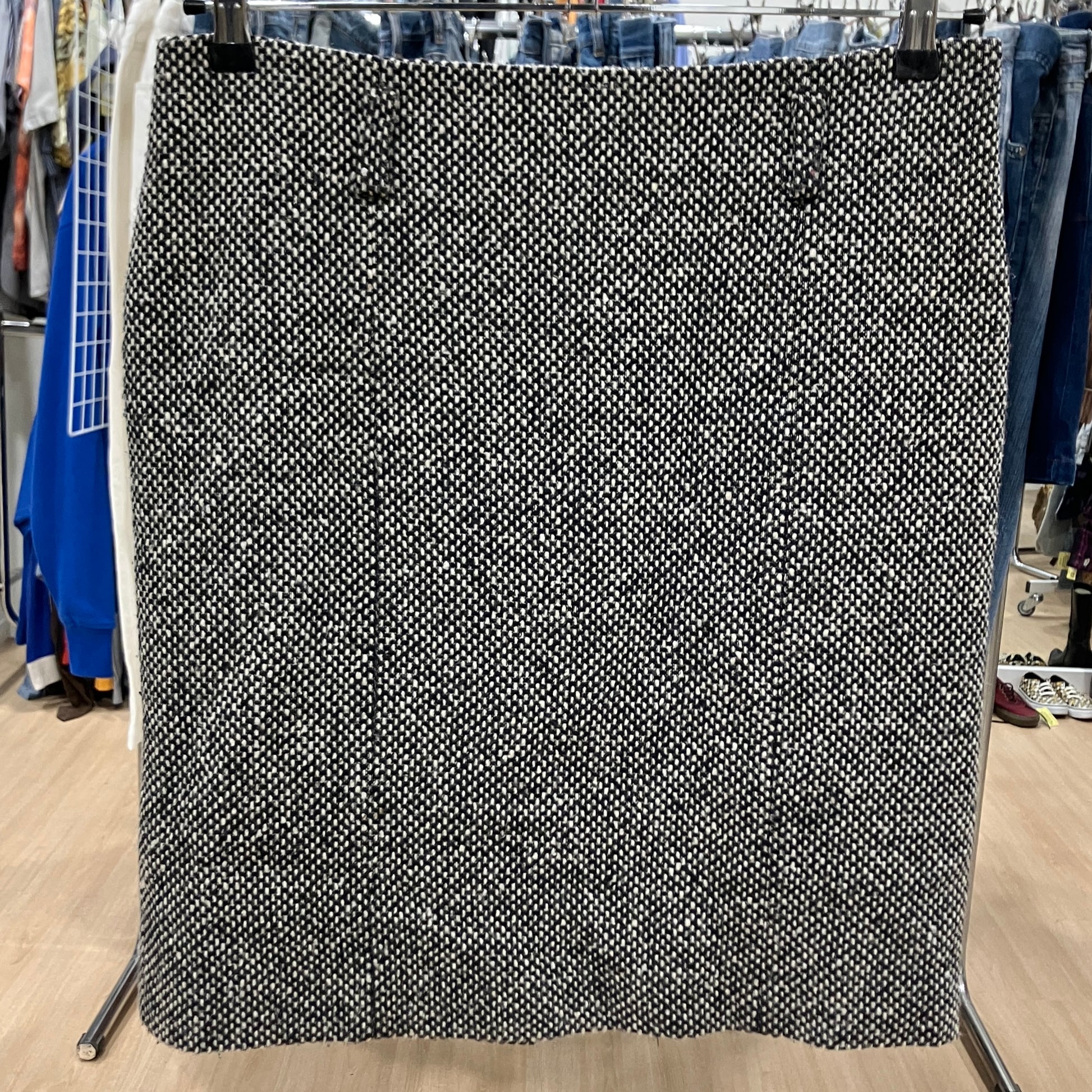 Black and white patterned fabric on a stand in a store setting