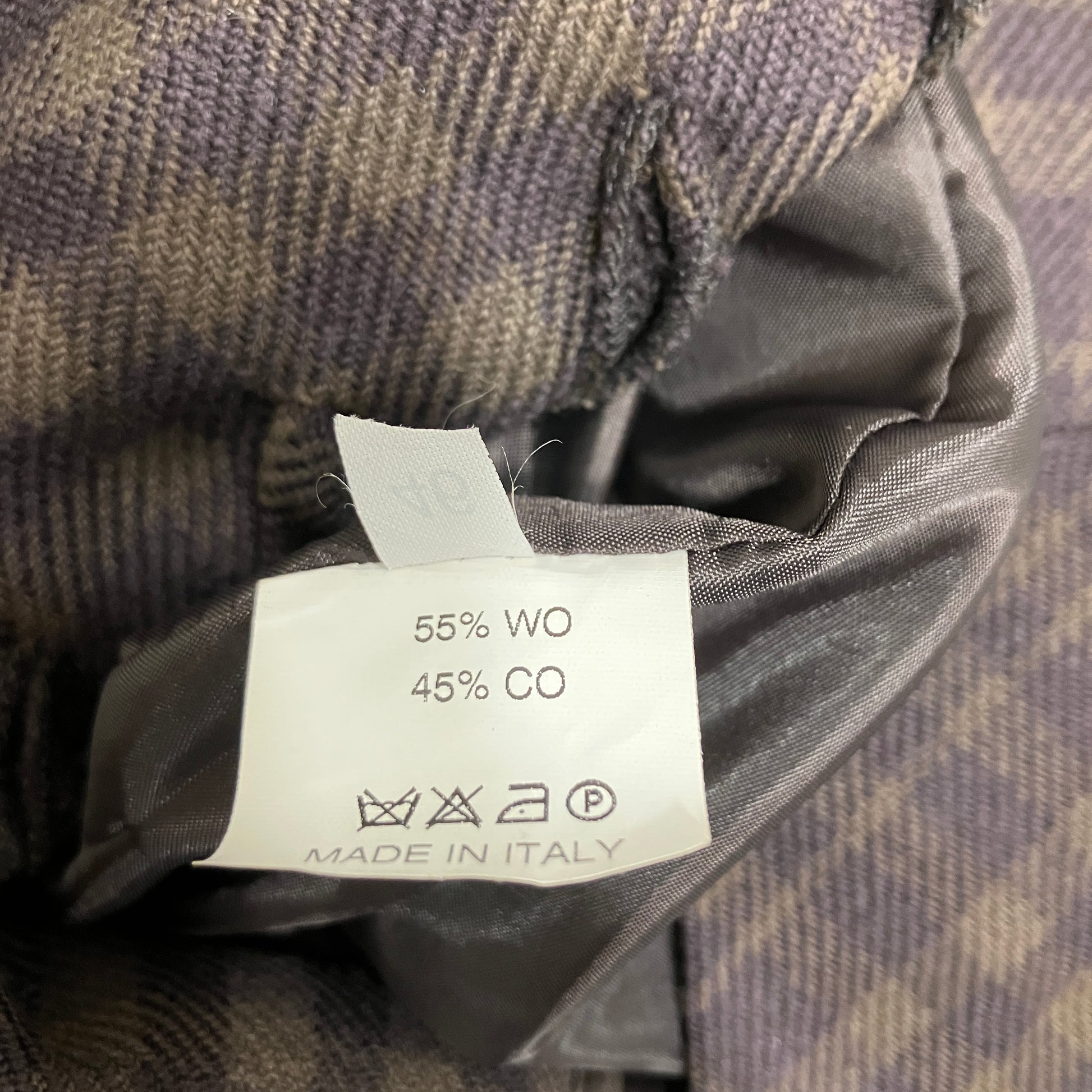 Clothing label with fabric composition details on a textured fabric background