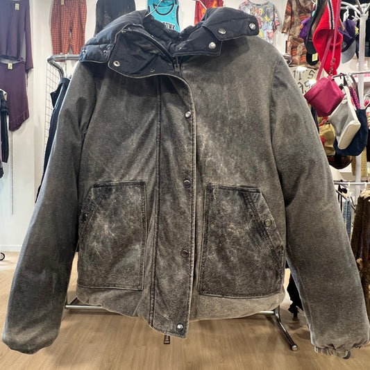 Gray distressed jacket on a rack in a store setting