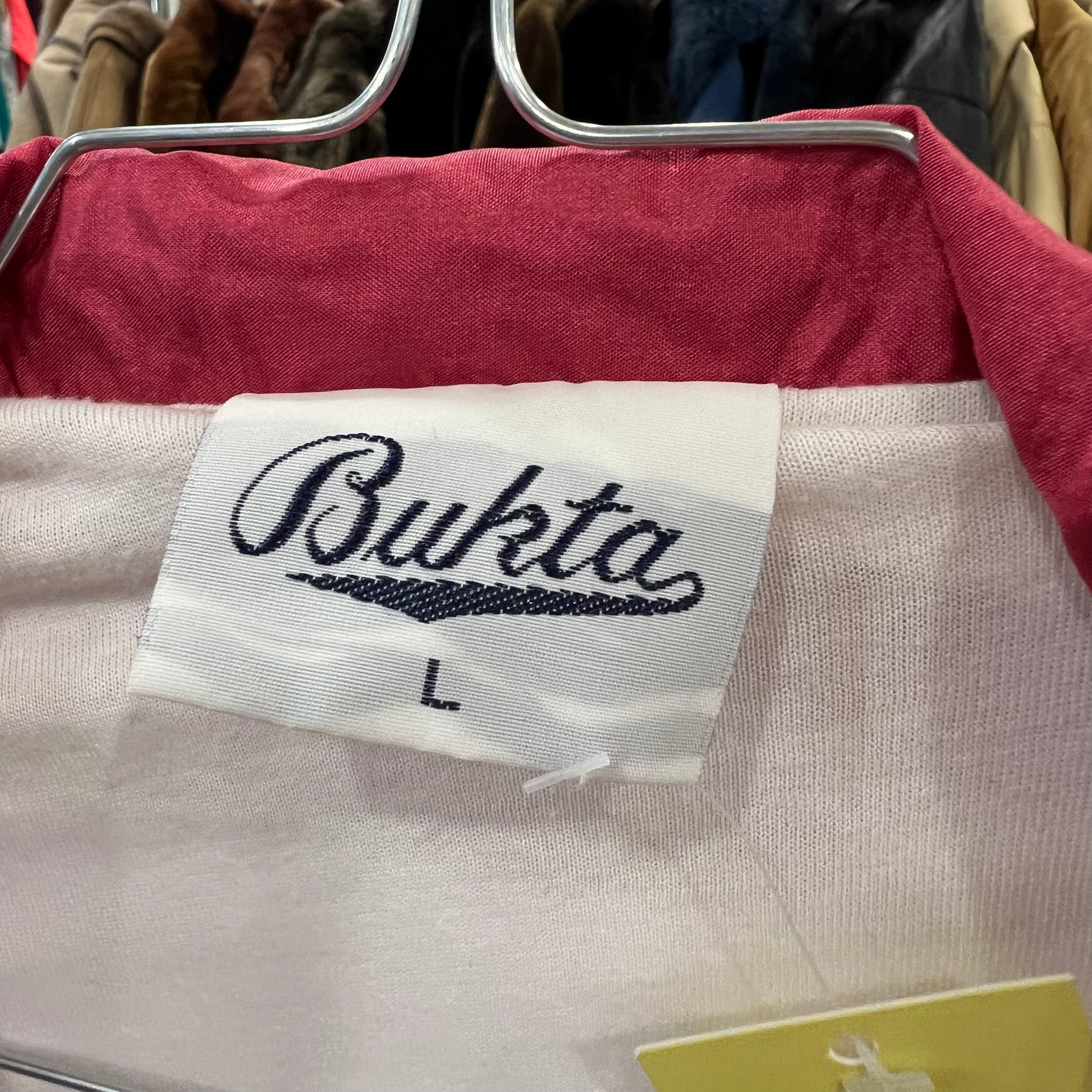 Close-up of a garment with a 'Bukta' label on a hanger