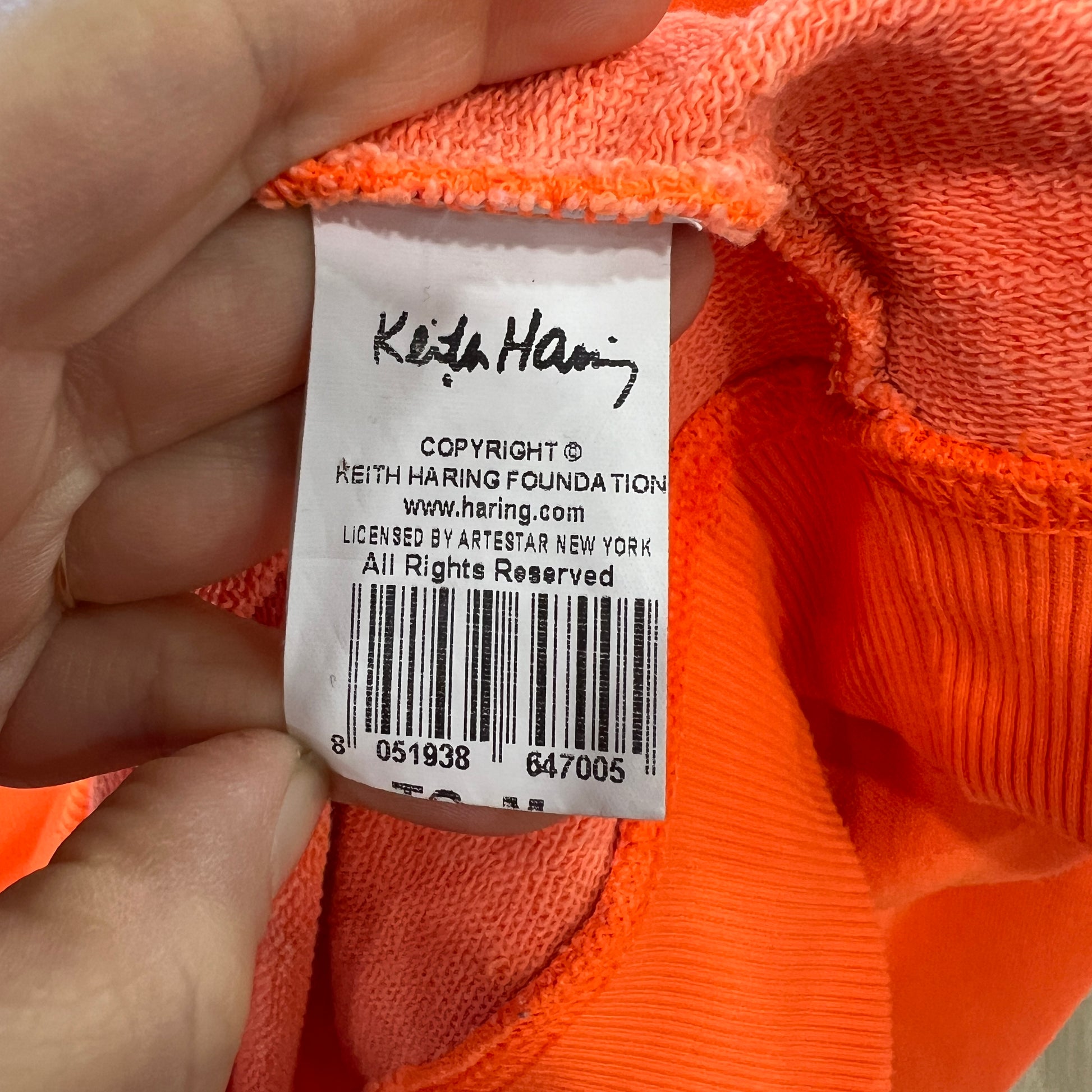 Orange fabric with a Keith Haring label