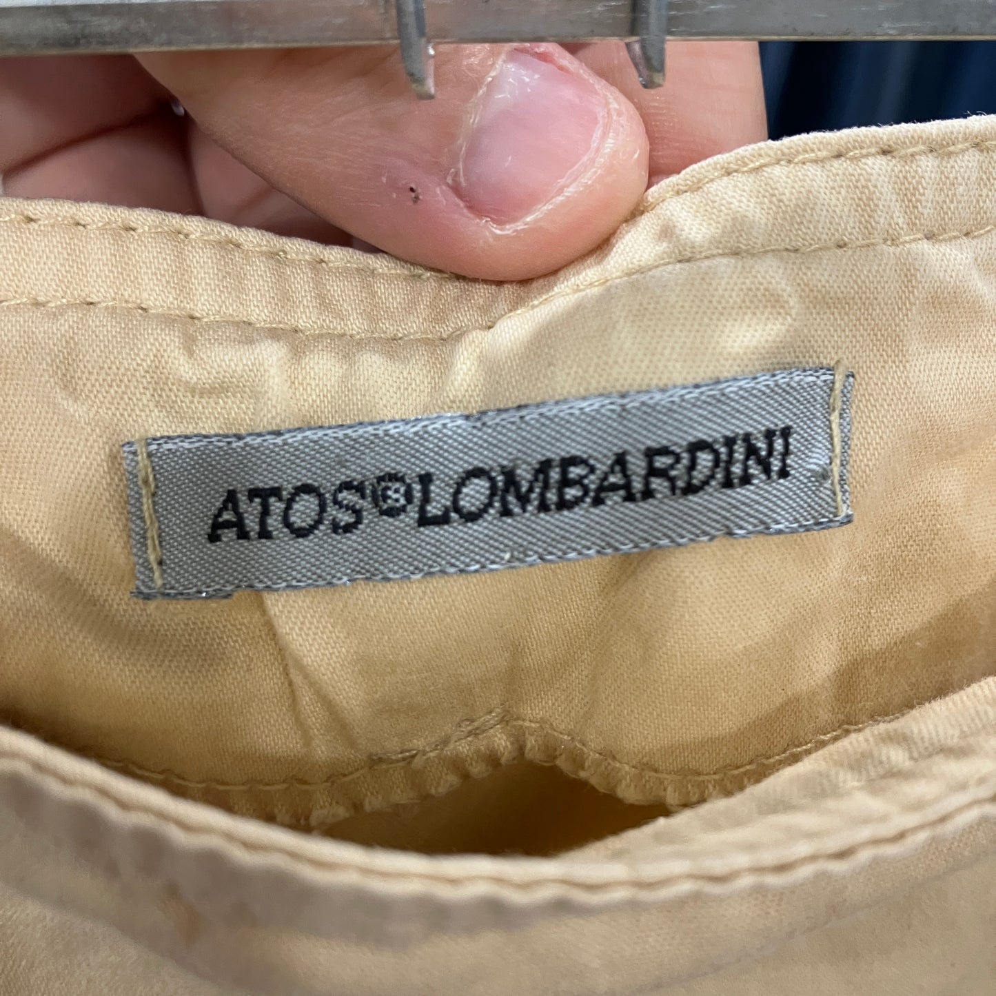 Close-up of a beige fabric with an Atos Lombardini label