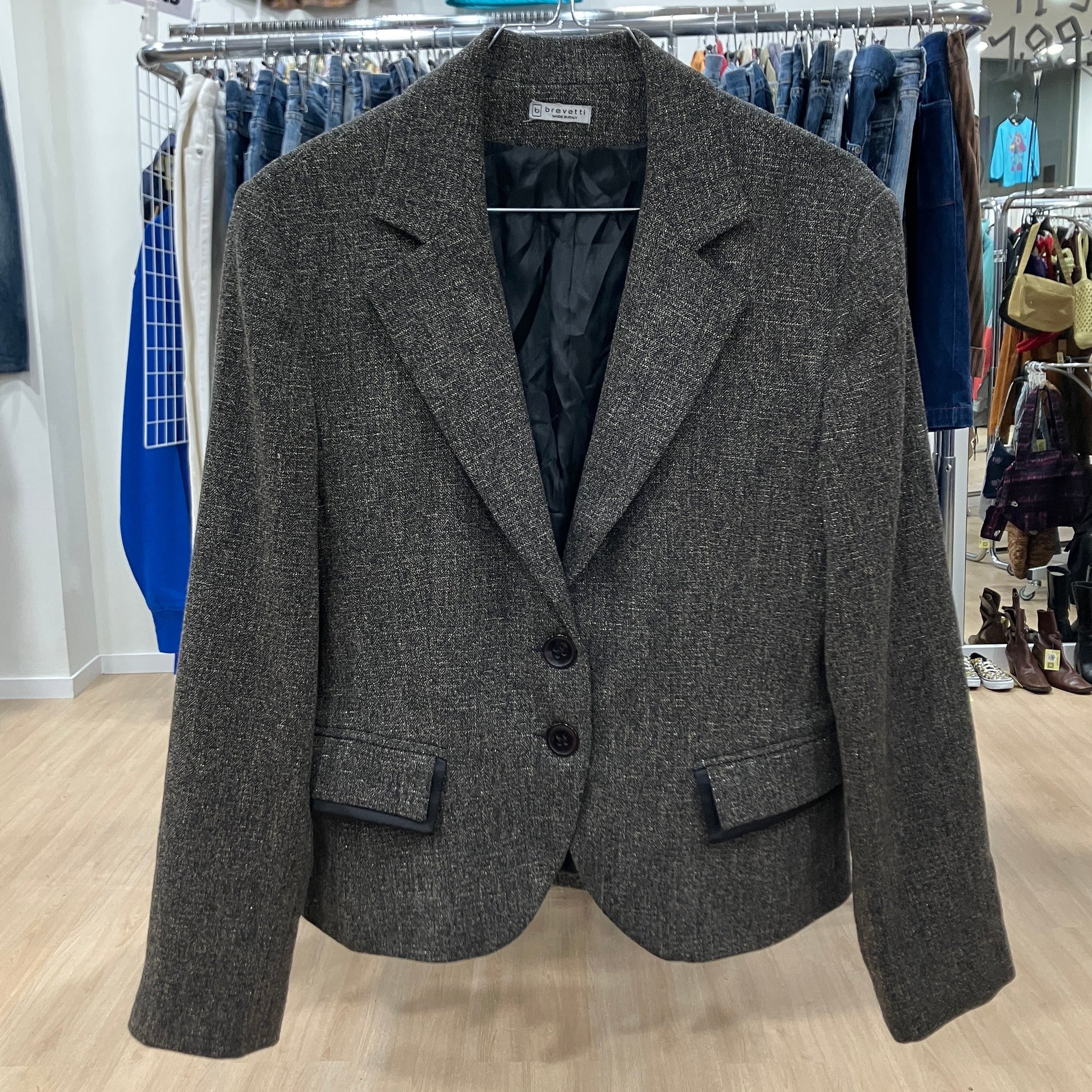 Gray blazer on a rack in a store setting