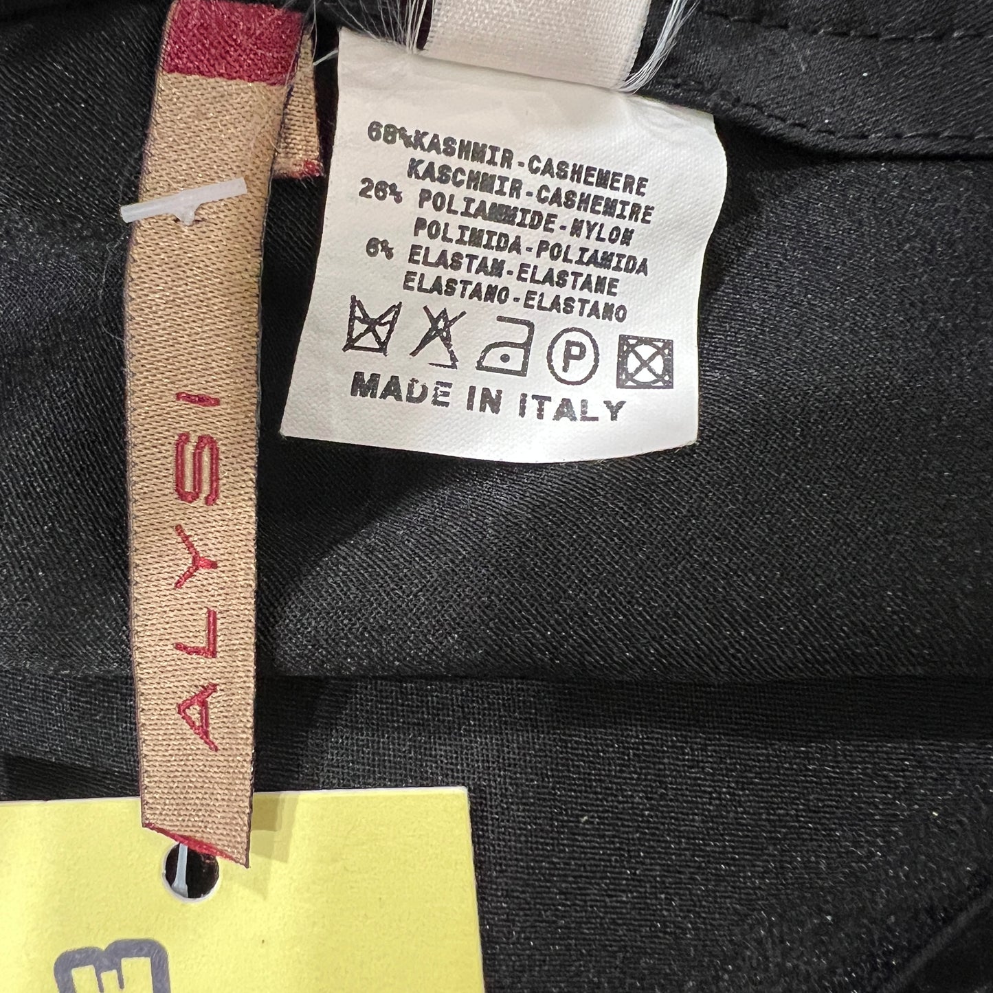 Clothing label with fabric composition details and brand name on a black garment