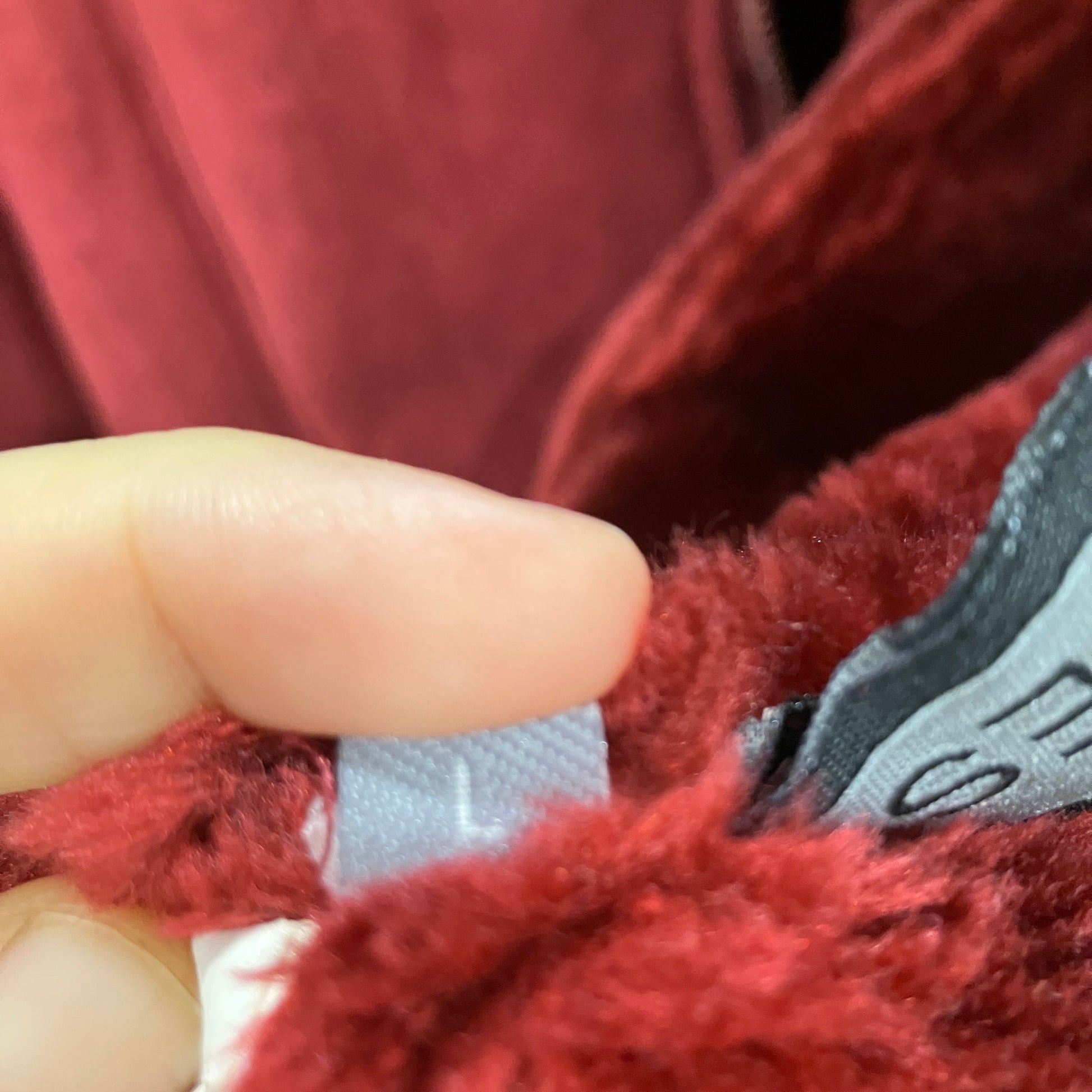 Close-up of a red textured fabric with a brand label