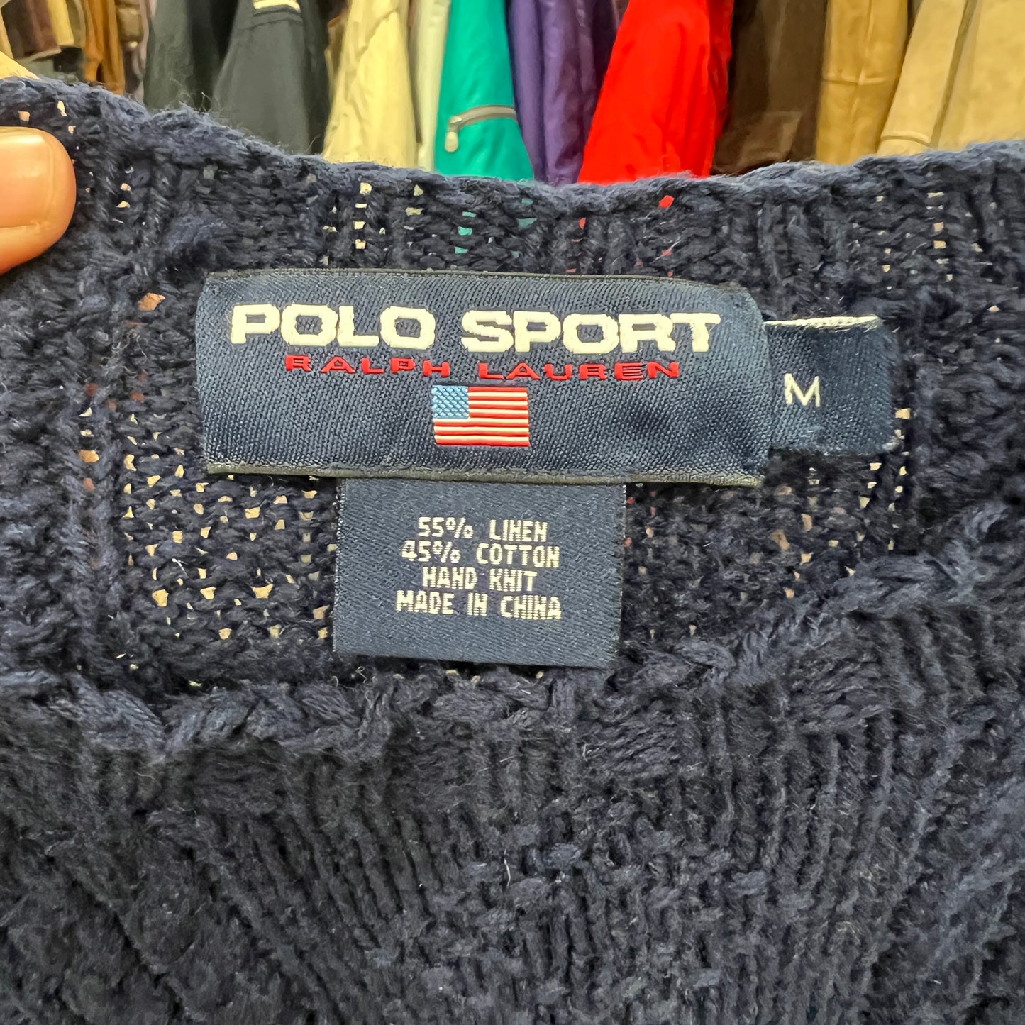 Polo Sport Ralph Lauren label on a knitted garment with clothing in the background