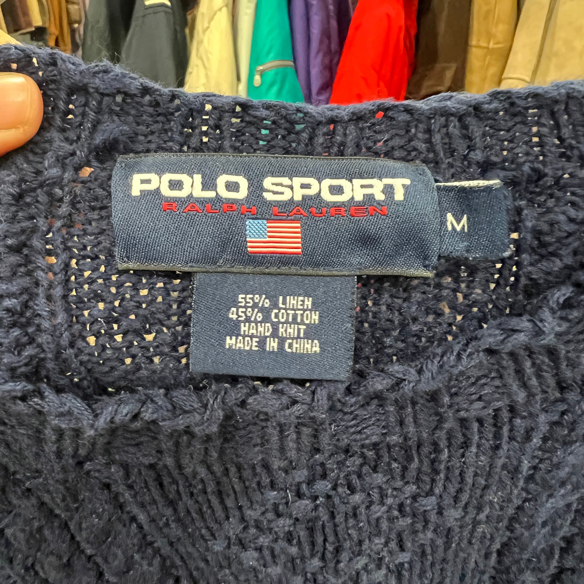 Polo Sport Ralph Lauren label on a knitted garment with clothing in the background