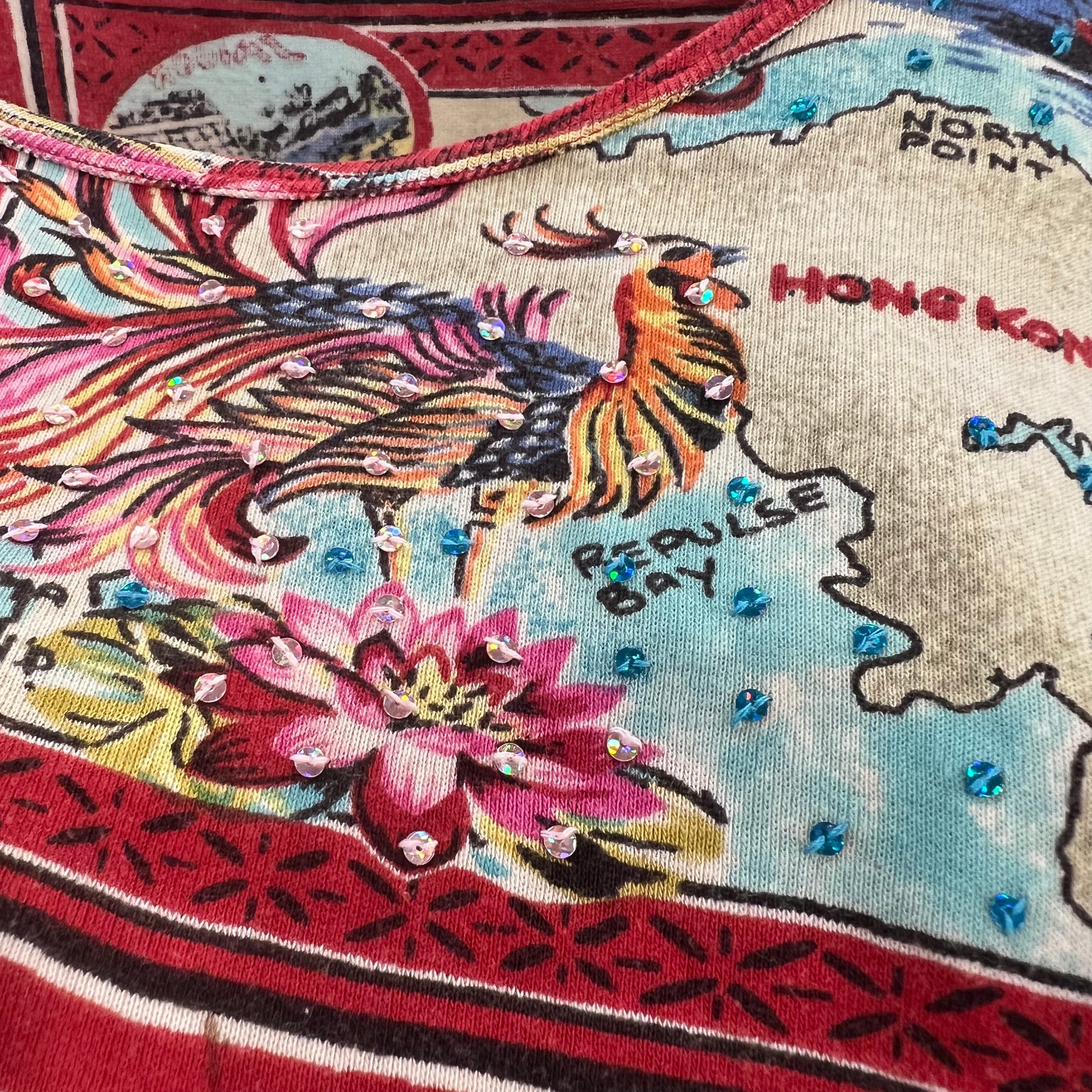 t-shirt close up with a map design featuring a rooster and lotus flower, with 'Hong Kong' and 'repulse Bay' text